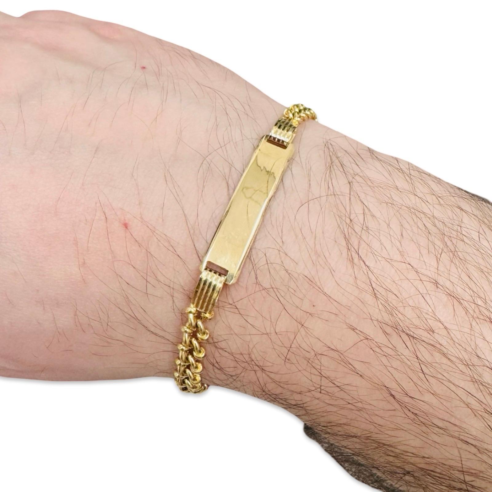 A refined vintage 18K gold ID bracelet featuring a classic rope-link chain and a sleek, polished rectangular nameplate. Weighing 10.3 grams and measuring 8 inches in length, the bracelet offers a balanced, substantial feel on the wrist without