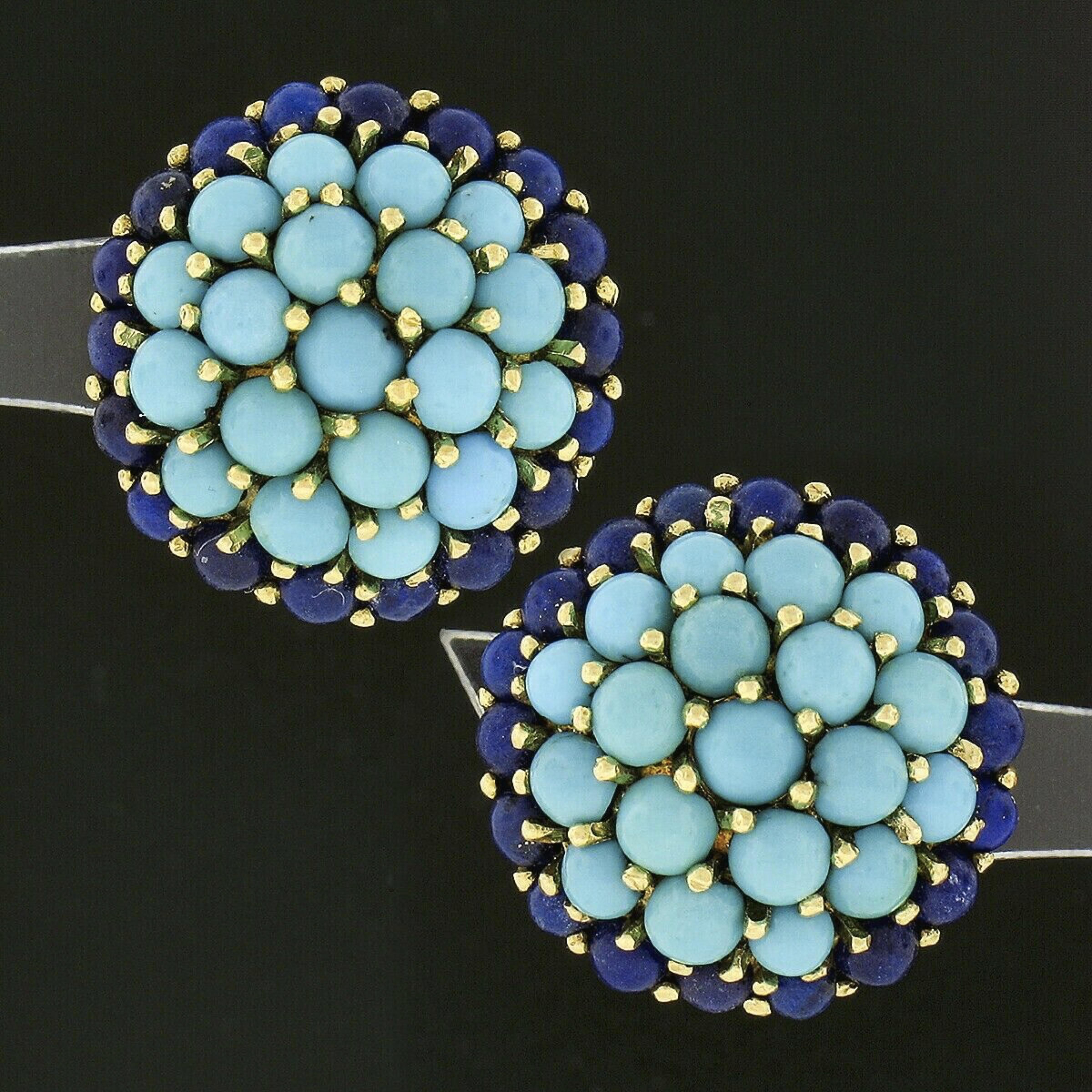 You are looking at a gorgeous vintage pair of natural turquoise and lapis cluster earrings crafted in solid 18k yellow gold. The cluster of round cabochon turquoise stones structure the slightly domed center of each earring, which is then surrounded