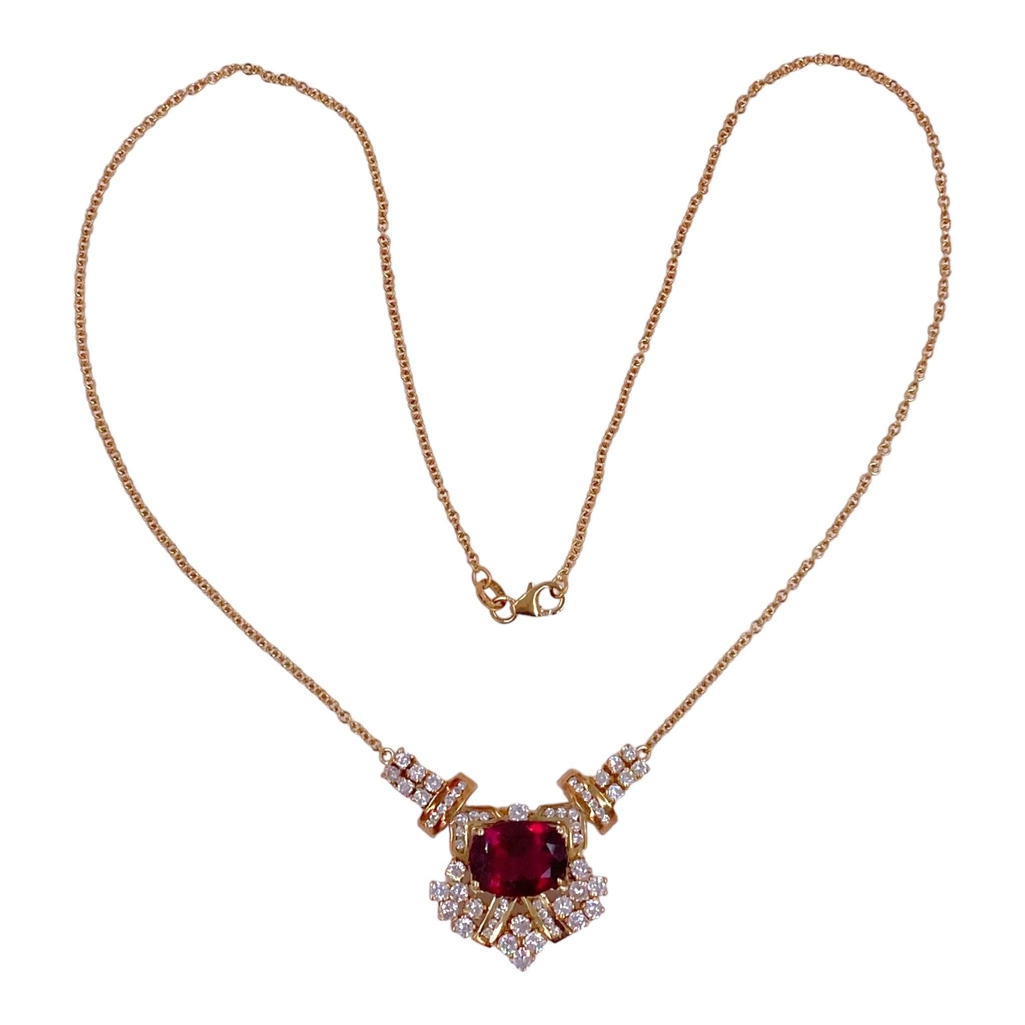 Crafted in 18K yellow gold, the necklace features an oval rubellite tourmaline set within an intricate diamond cluster setting.
Rubellite: 5.0 carats
59 round brilliant cut diamonds: 1.75ctw. Color: G-H, Clarity: VS2-SI2
Measurements:
Front: 31 mm L