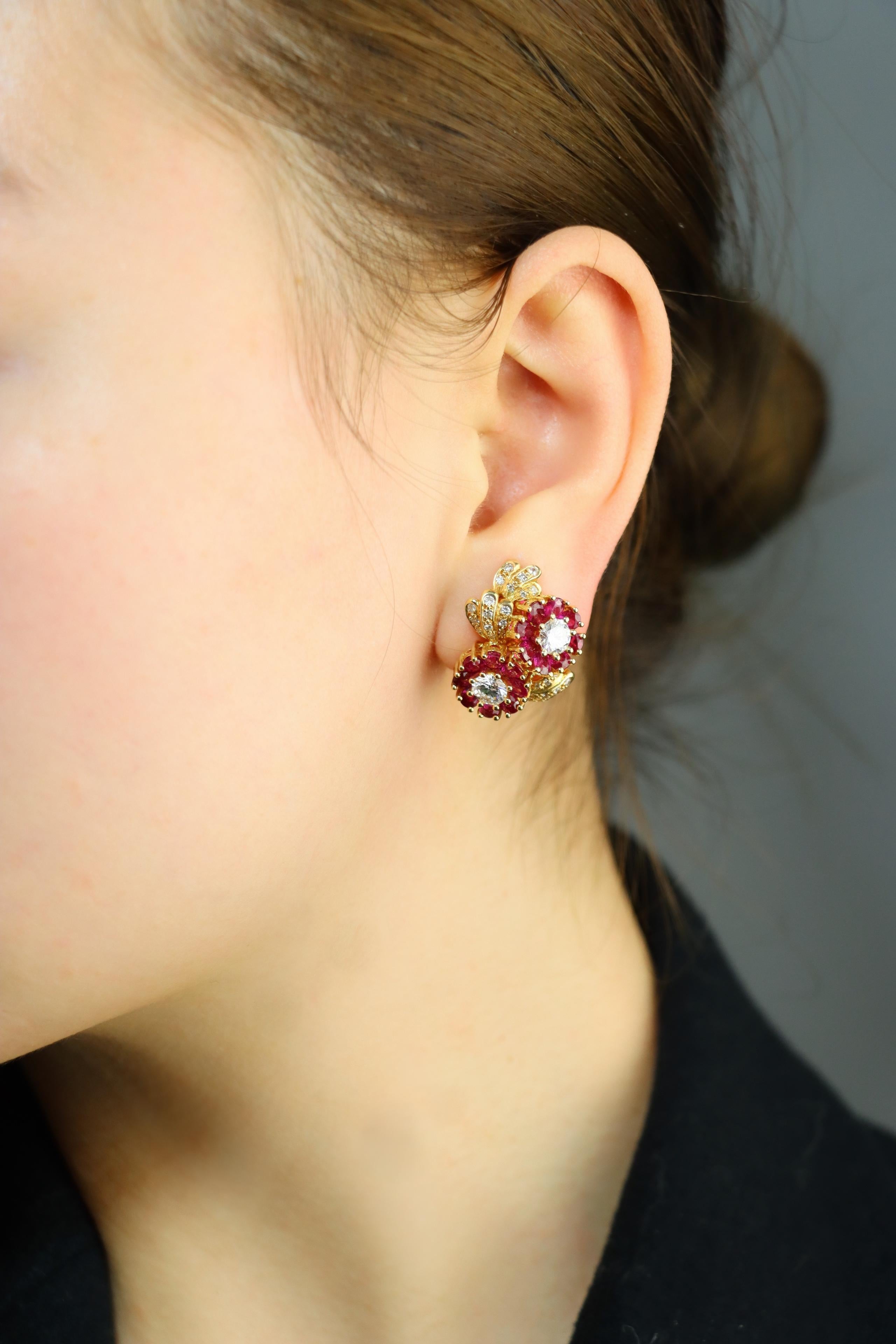 Vintage 18K Gold Ruby Diamonds Flower Earrings

Marked:
18K

Approximate Dimensions:
2.3 cm (Length) 
2.1 cm (Width)
6.46 carat (Ruby)
2.40 carat (Diamonds)
17.6 grams in weight.