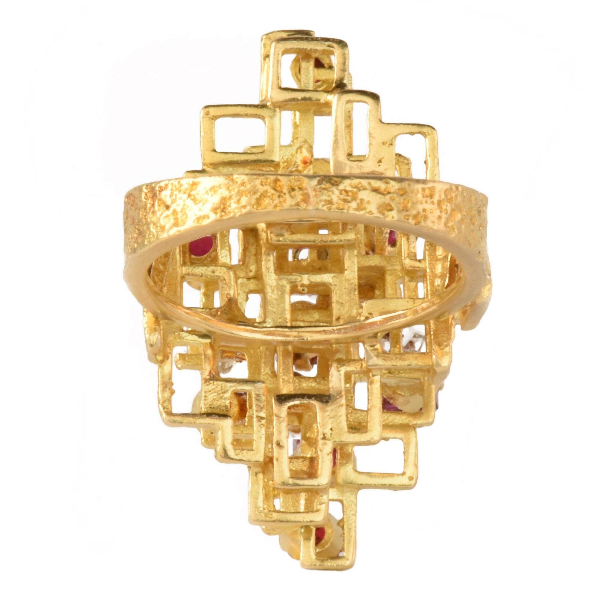 A fabulous vintage statement ring.

Designed as a series of bark textured rectangles in 18k yellow gold.

Set with square step cut rubies and round brilliant cut diamonds.

Attributed to George Weil. A similar example can be found in the collection