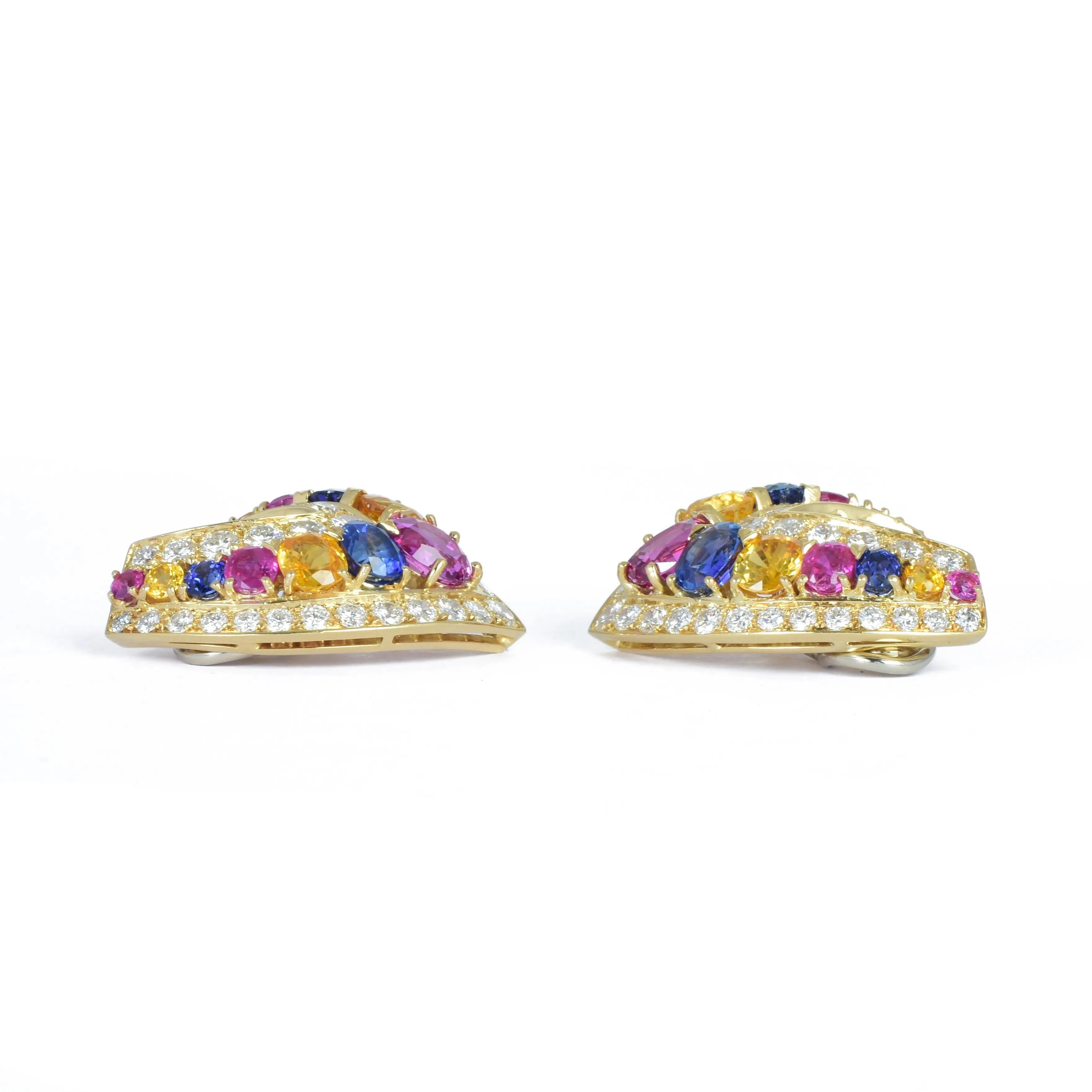 A sumptuous large pair of  gem set clip earrings.

Dating from the 1980s, Italian in origin undoubtedly

Modelled in 18k yellow gold set with pink, yellow and blue sapphires within a frame of bright white diamonds.

Superb quality throughout. bright