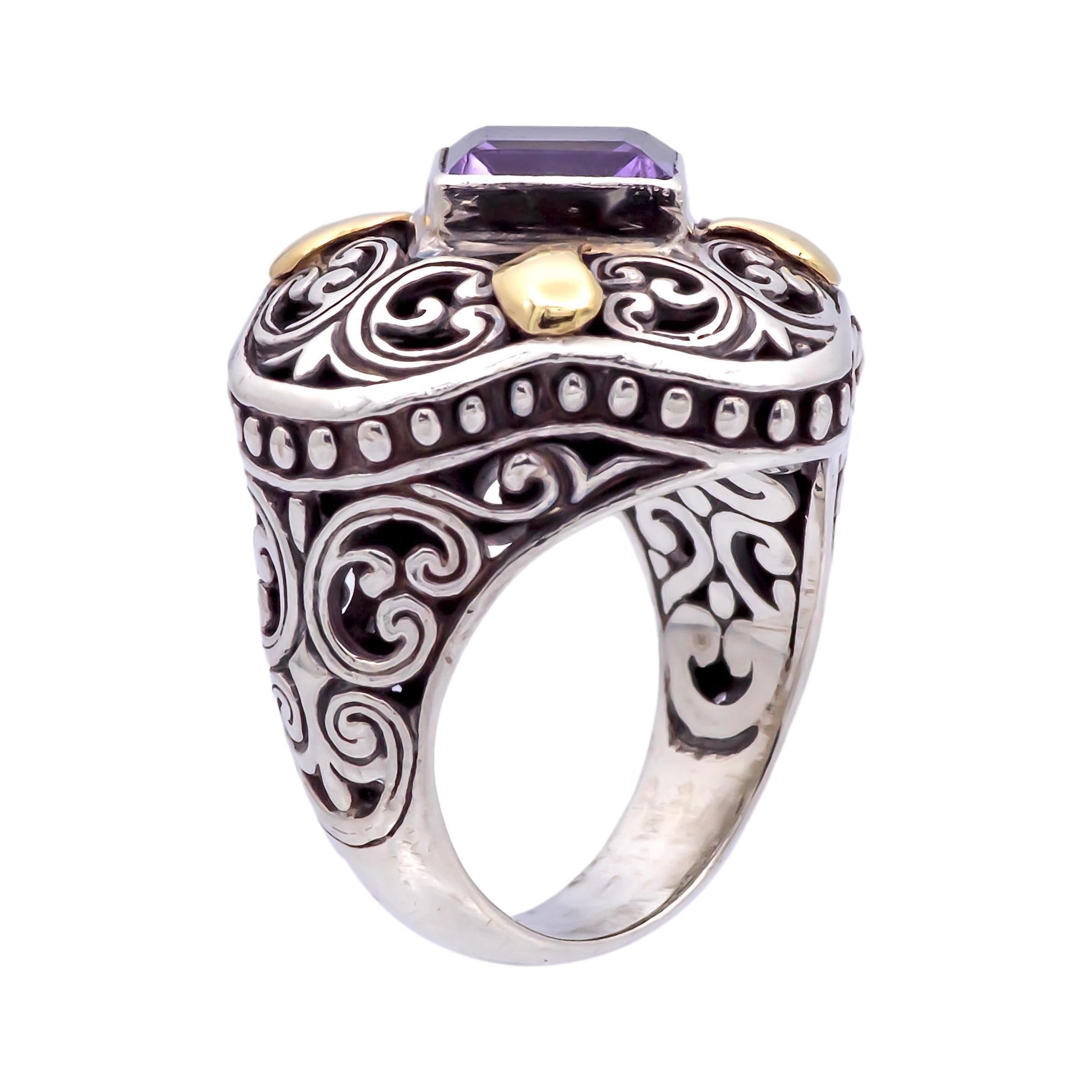 Vintage cocktail ring finely crafted in blackened sterling silver with 18 karat yellow gold accents featuring a square shape amethyst set in a bezel. The ring has a chunky feel. and measures 25mm at all sides on the top. Scrollwork details are all