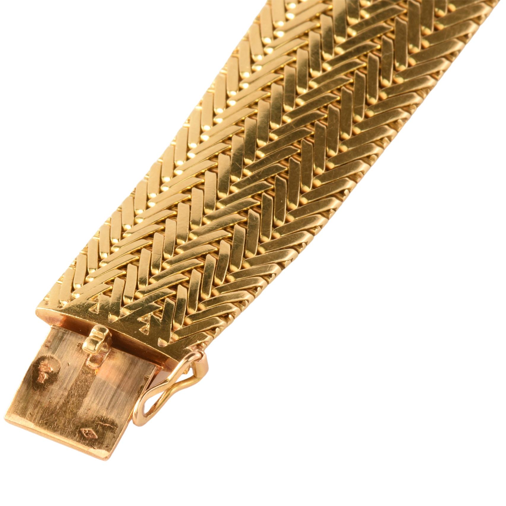 A fabulous stylish and sleek vintage bracelet by George L'Enfant. Crafted from 18k woven yellow gold if tapered form. Has 18ct double struck eagle heads (french) & George L'Enfant makers marks on the bracelet. Supplied with Cartier box.