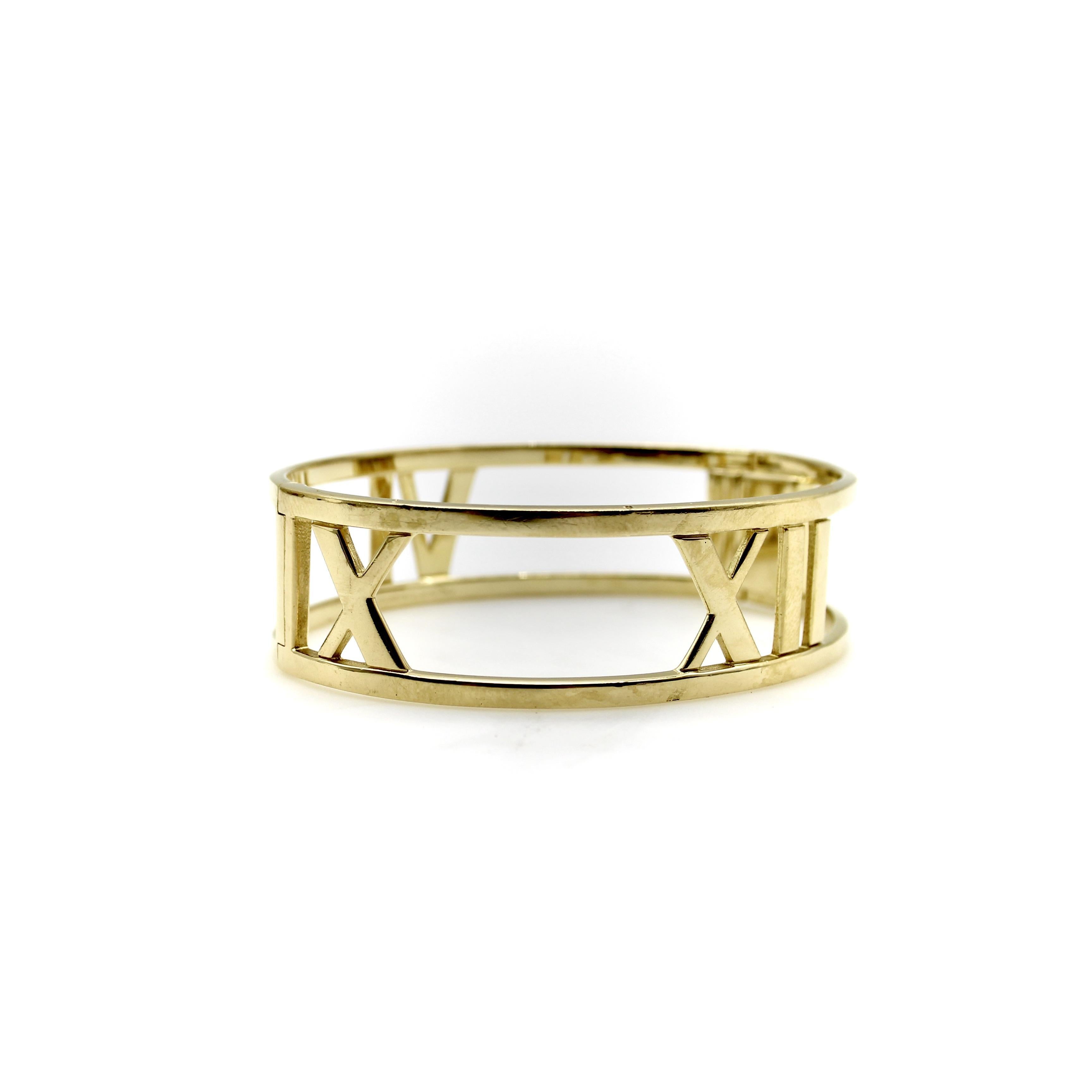 This 18k gold Tiffany & Co. bracelet is a classic Tiffany design from the Atlas collection. Inspired by the Atlas clock that infamously stood in front of the Tiffany & Co. store for over a century, the bracelet features the roman numerals 3, 6, 9,