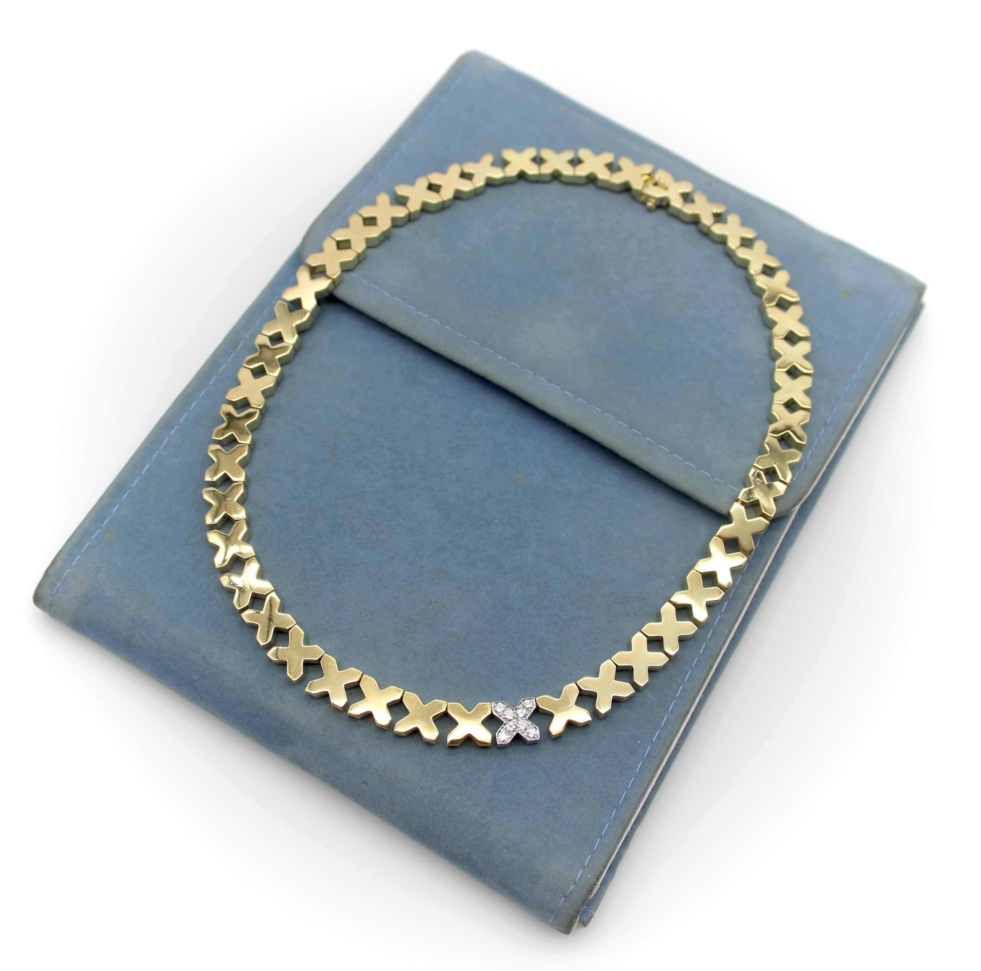 This vintage 18k two-toned gold diamond X necklace is a masterpiece by Angela Cummings for Tiffany & Co as part of the 1975-1976 collection. The exquisite design consists of 43 gold links with a high-polish finish and one white gold, diamond