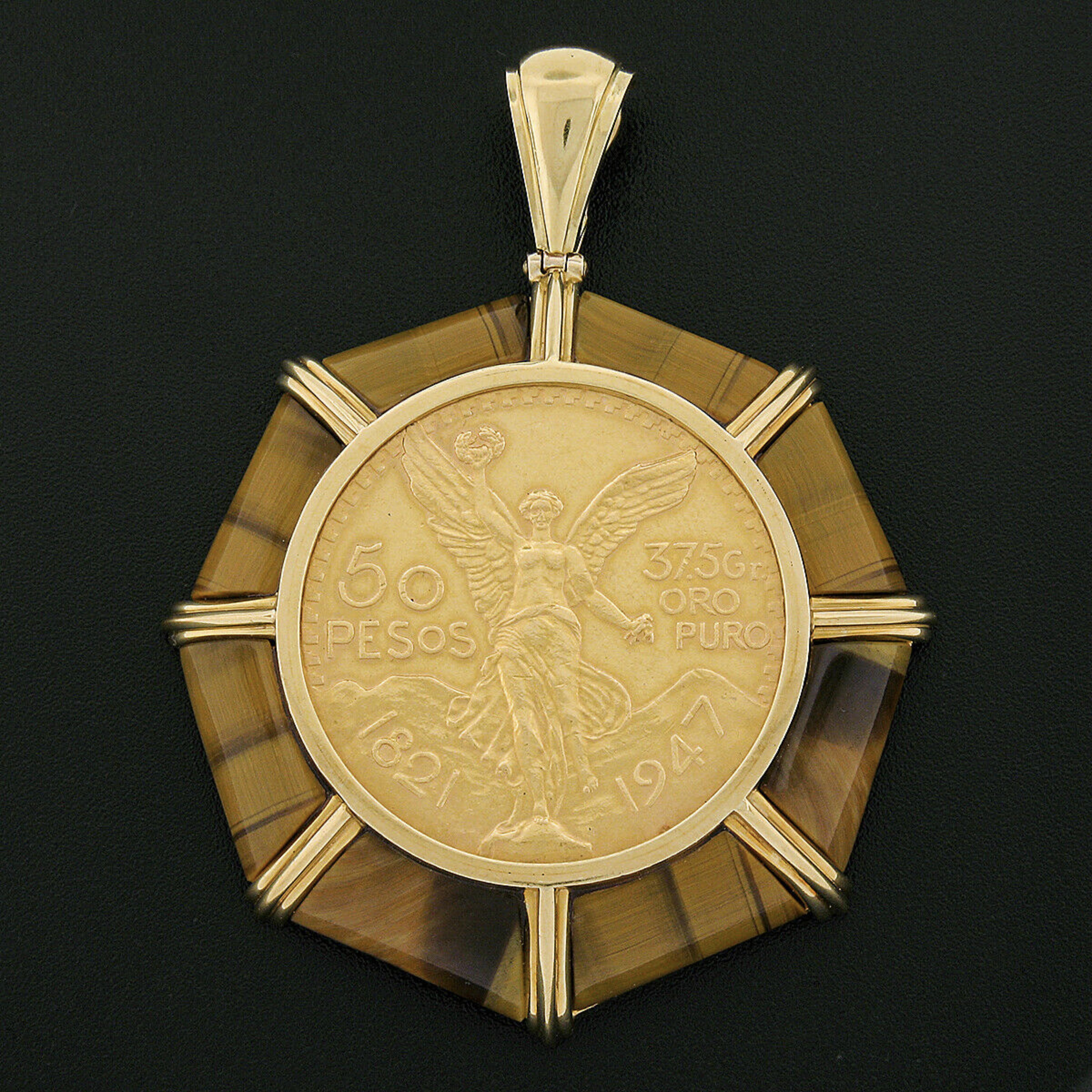 This large and impressive vintage pendant was crafted from solid 18k yellow gold and features a 50 pesos Mexican coin piece neatly bezel set at the center. The large coin is surrounded by a magnificent frame constructed from custom cut, polished,