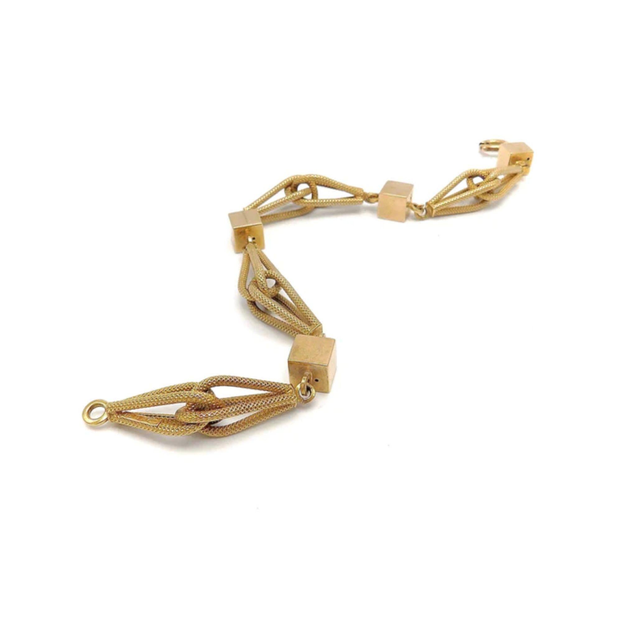 This fabulous 18 karat gold bracelet is by Italian company UnoAErre.  It features a modern and fun link. Whisk shaped links with a diamond texture interlock creating four bold segments adding to the mix another four cube shape connectors complete