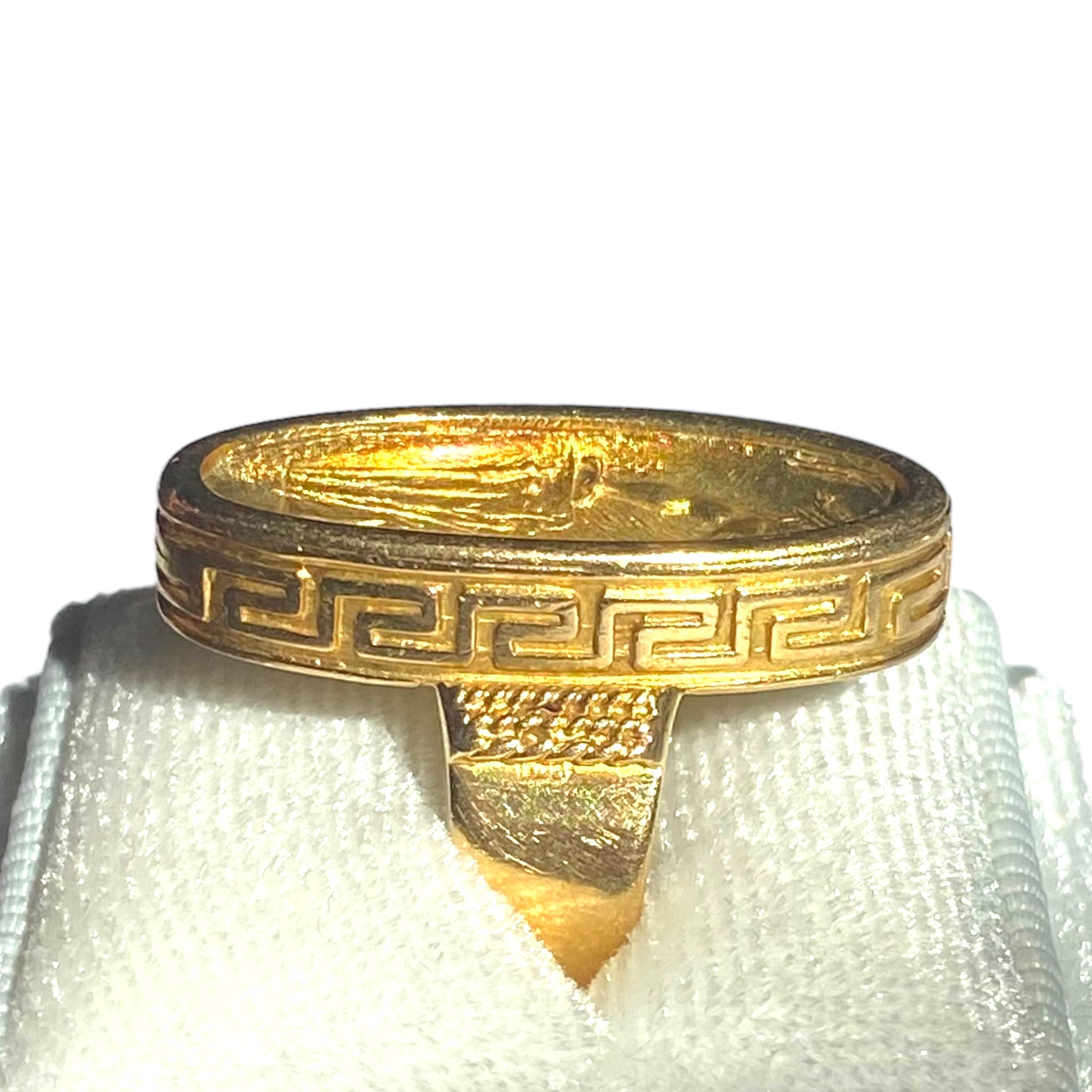 Crafted in 18K yellow gold, the ring features an oval repoussè cameo of a Greek figure in a Greek key design bezel.
Measurements:
Front: 27.5 mm H x 12 mm W x 5.5 mm D
Band: 5.3 mm
Weight: 11.3 grams
Size: 6 (sizable)
Marked GK 750 ZL