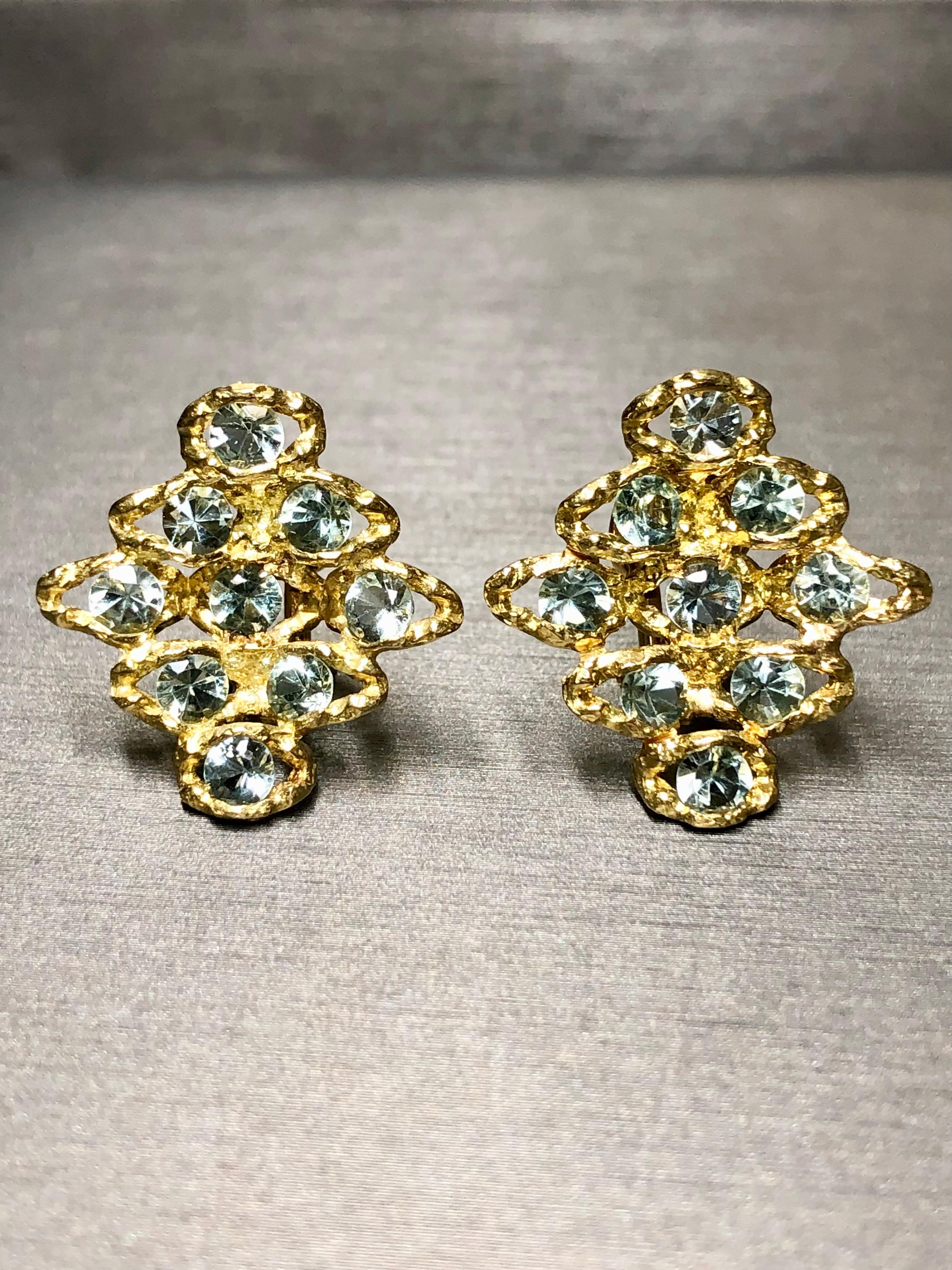 
A beautiful and retired pair of vintage earrings by H. Stern done in 18K textured yellow gold prong set with approximately 5cttw in round cut aquamarines. Earrings are clip-on with omega backs.


Dimensions/Weight:

Earrings measure .95” in