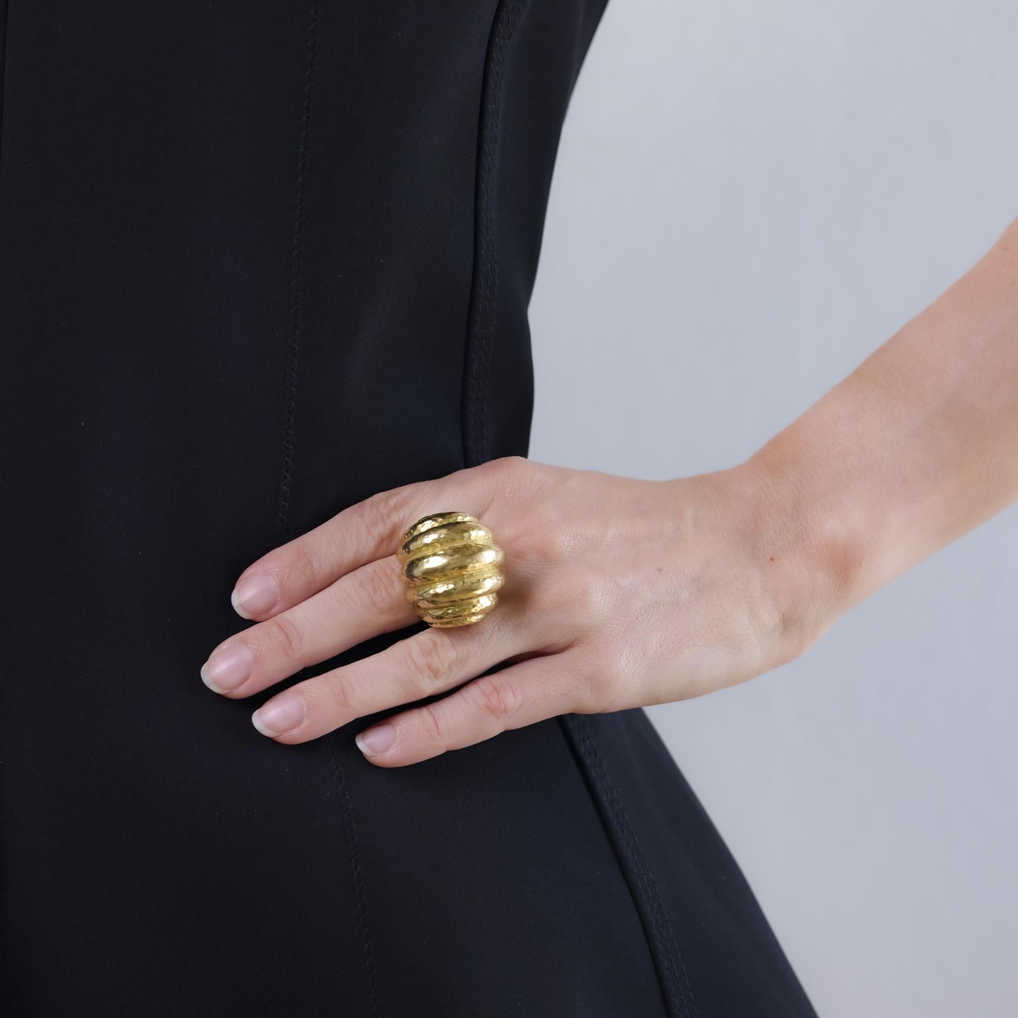 This vintage ring from the 1980s is crafted in solid 18k yellow gold and features a bold, substantial design characteristic of the era. With its high polish finish and generous weight, it makes a striking statement while maintaining timeless