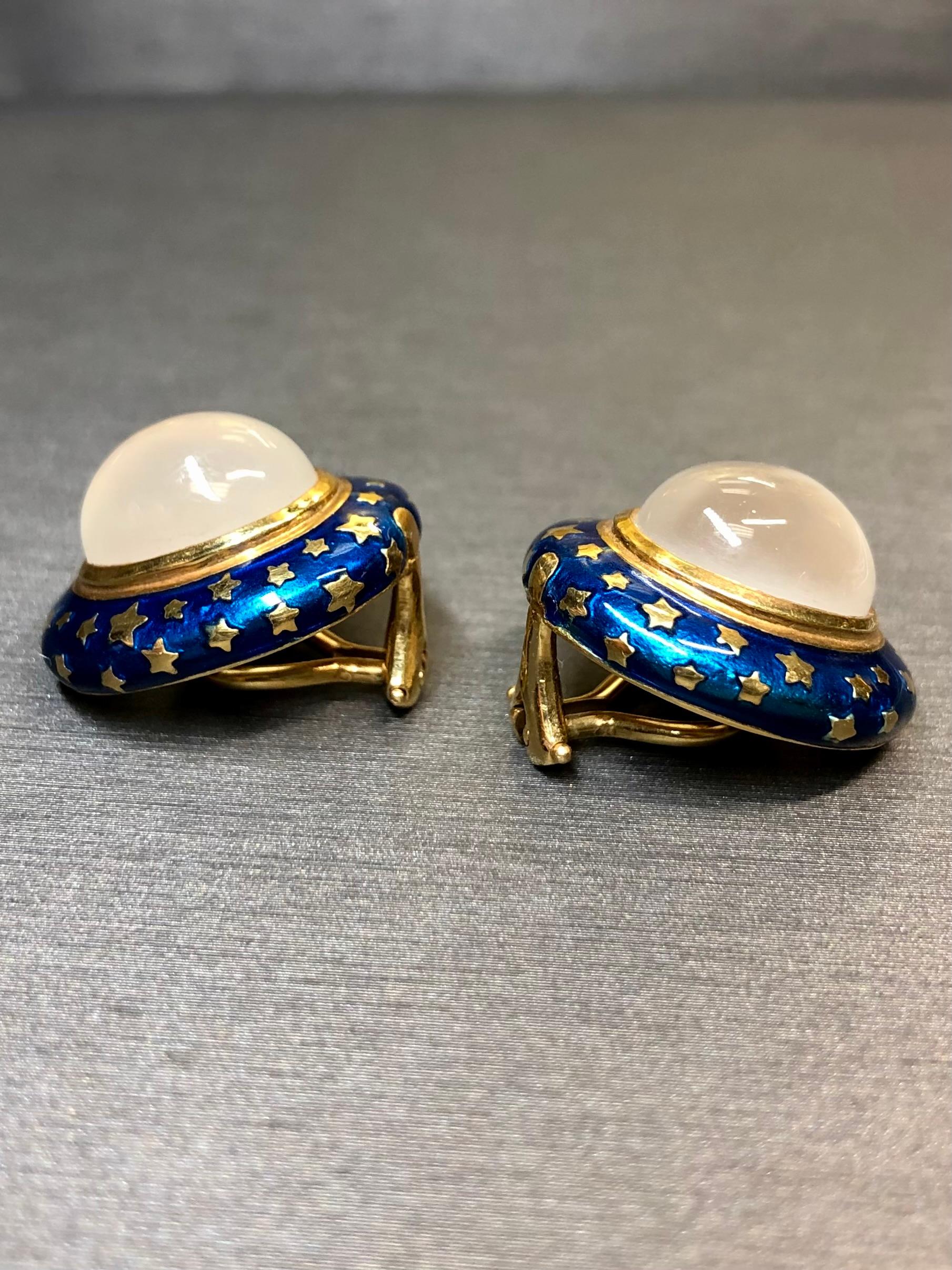 Rare, vintage clip-on earrings by Herbert Roaenthal. They are done in 18K yellow gold finished with cobalt blue enamel and centered by approximately 12ctw in natural cabochon cut moonstones. Posts can be added upon