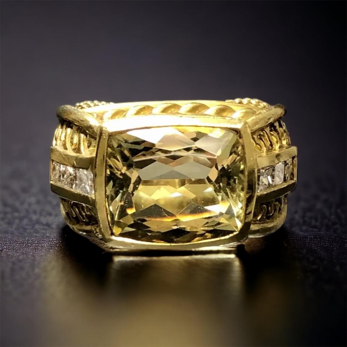 A beautiful and heavy ring done in 18K deep yellow gold by famed designer Judith Ripka. It is centered by a natural lemon quartz measuring 12.30mm x 10.60mm x 6.65mm. Flanking the center stone are 6 princess cut diamonds being G-I in color and Vs1-2