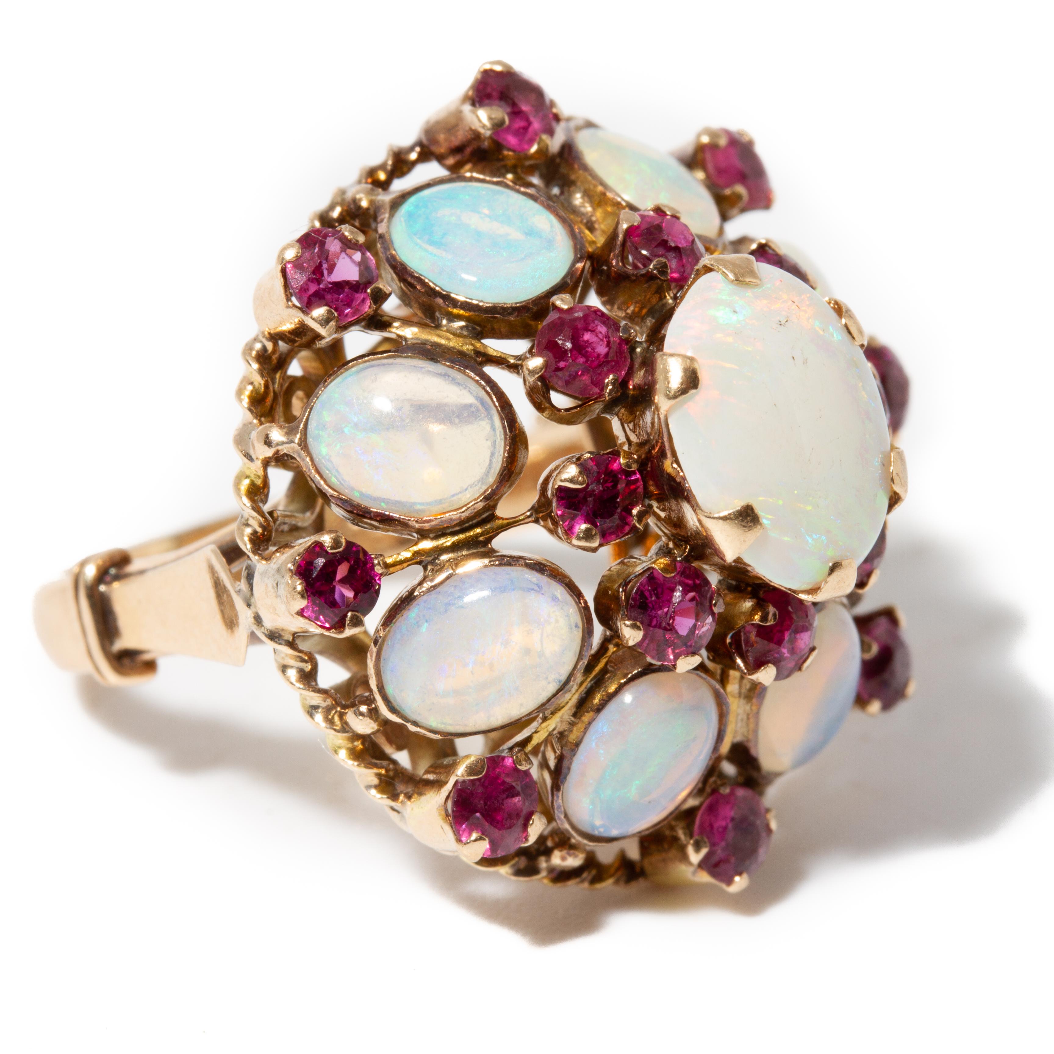 18K gold mid-century modern vintage cluster ring with nine natural opals surrounded by ruby accents, stamped: “18K,” ring size: 5.75. Approx: 4.18 dwt (6.5 grams).