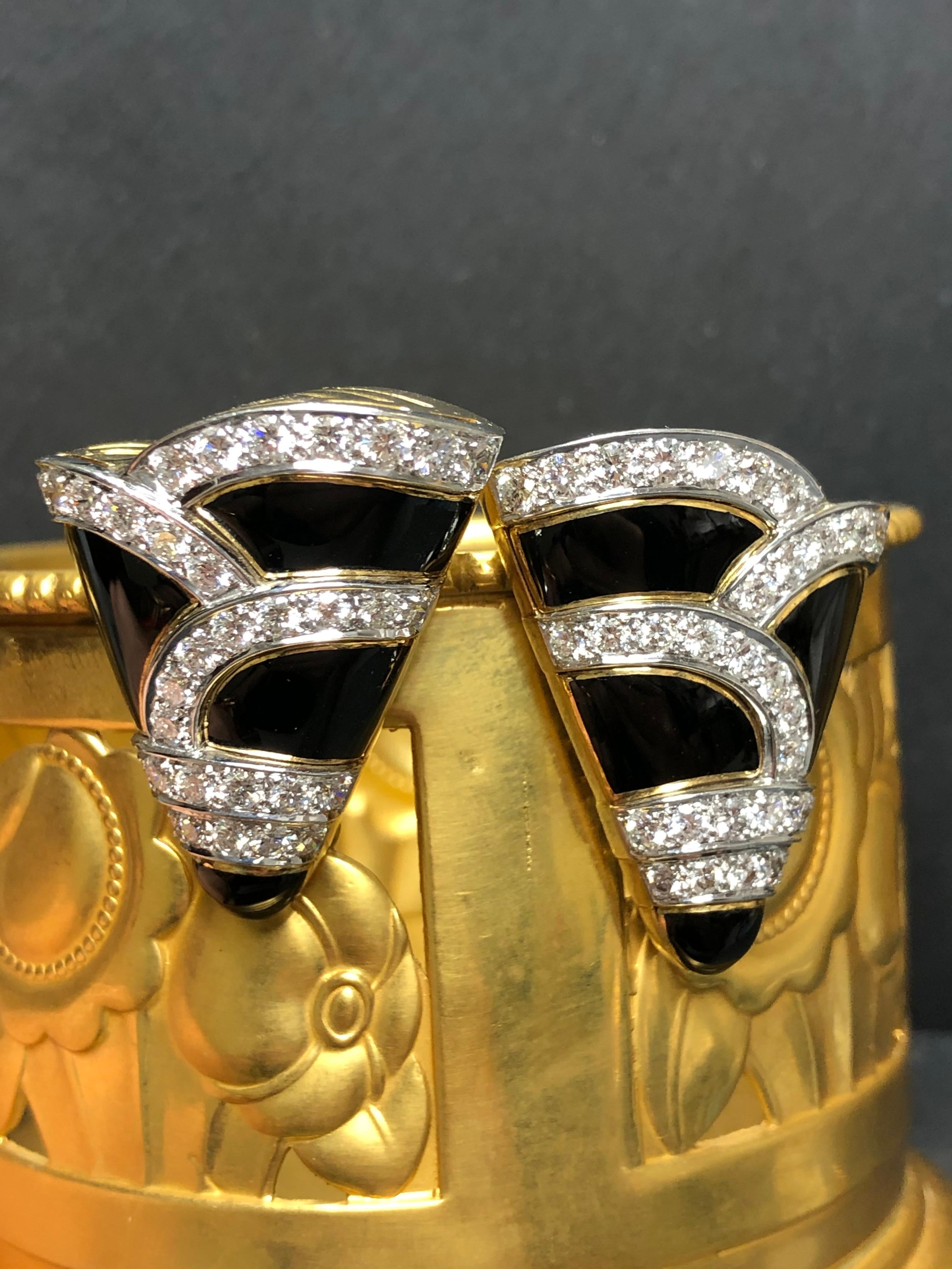
An incredible pair of earrings that have no excuses to be made. They are done in 18K yellow gold and platinum and set with approximately 4cttw in perfectly cut and matched F+ color and Vs1+ clarity round diamonds. The enamel portions are made