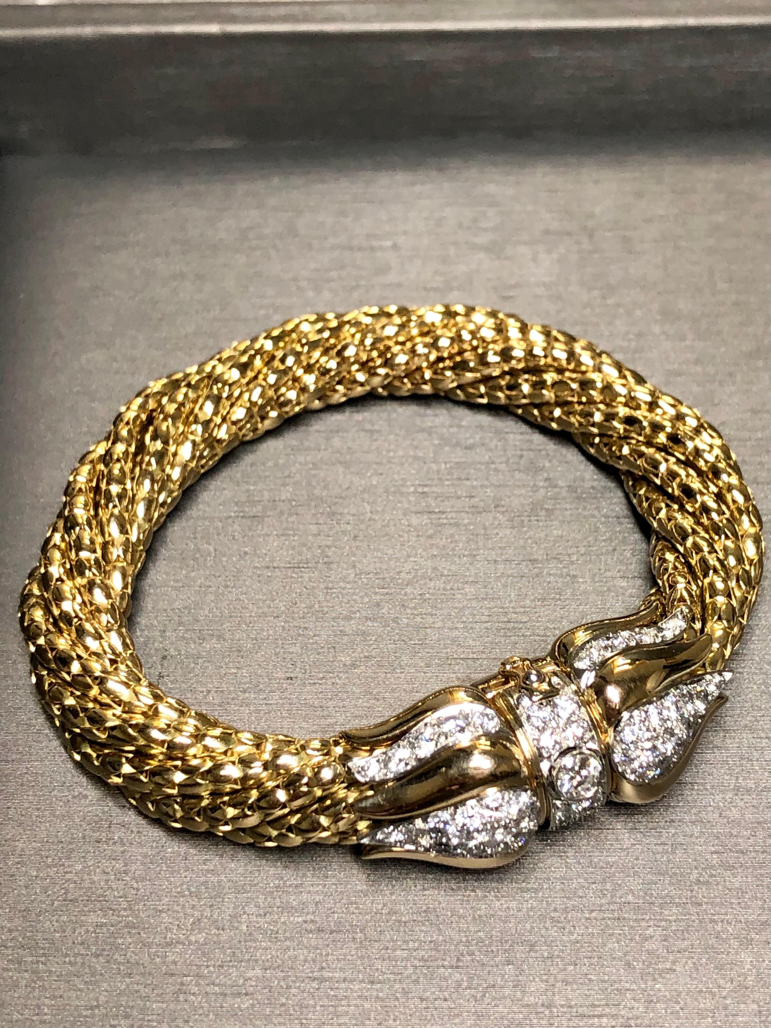 An incredibly well made bracelet done in 18K yellow gold and platinum comprised of 7 independent sections twisted together and held in place at either end. The piece is finished off with an incredible clasp done in 18K and platinum and set with