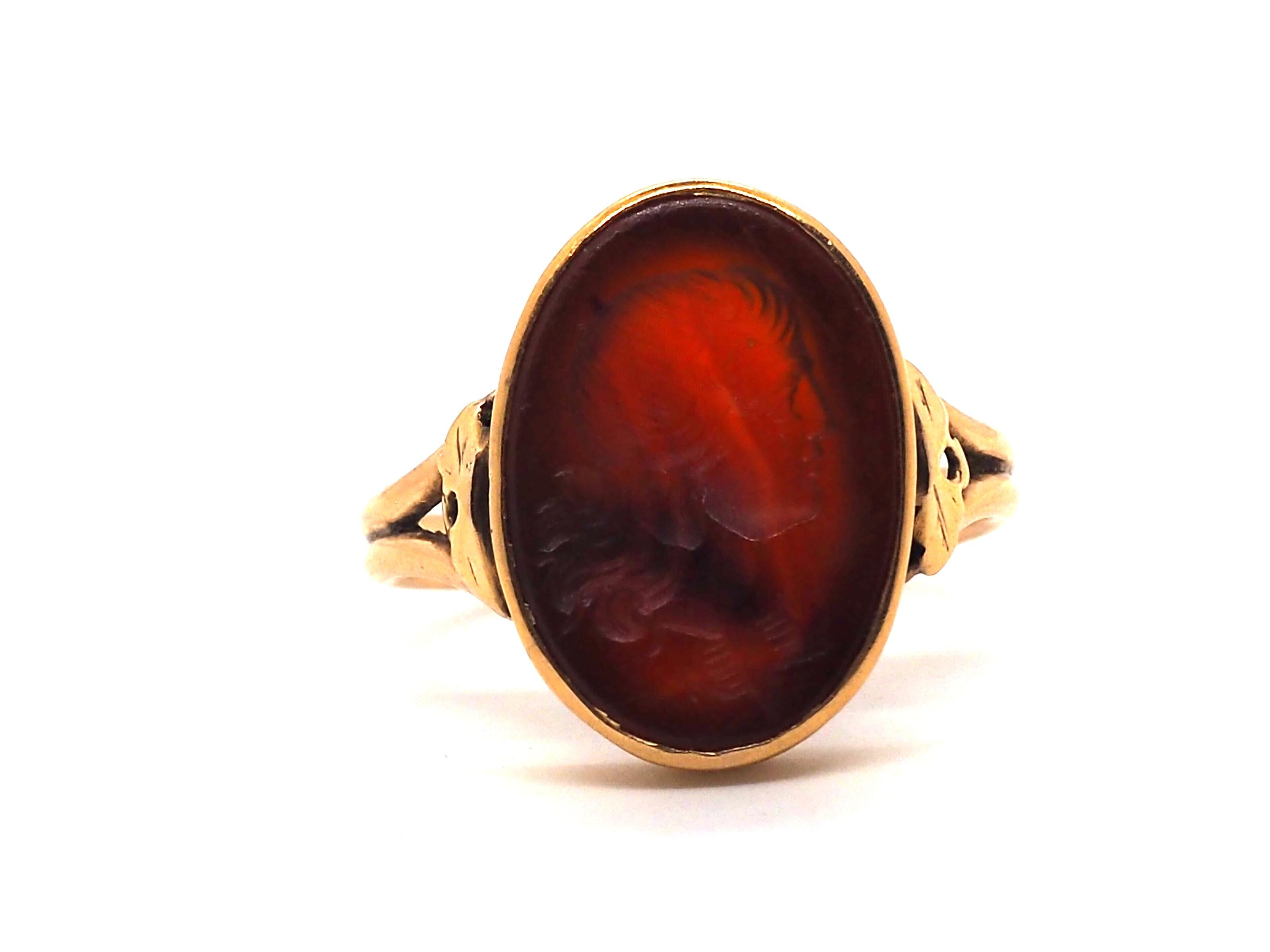 Antique ring crafted in 18 Karat rose gold 
Discover the epitome of elegance with our exquisite 18k Rose Gold Ring decorated with a carved oval Carnelian. 

Meticulously crafted to perfection, thist stunning piece showcases a relief engraving of a