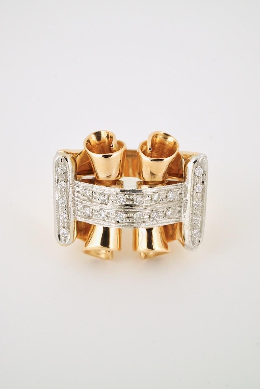 A vintage Retro 18k rose gold and diamond ring of a bold design of two scrolls under an arched bridge type design set with 22 round brilliant cut diamonds in 18k white gold on a wide 18k rose gold tapered shank - marked 750 for 18k gold and with