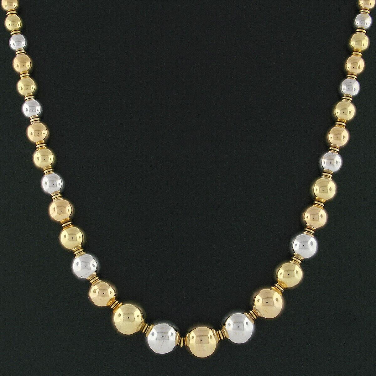 Here we have a unique vintage statement piece that's crafted in Italy from solid 18k gold. It features smooth and polished gold ball beads that graduate in size from approximately 6mm at the back to approximately 14.3mm at the front. These beads