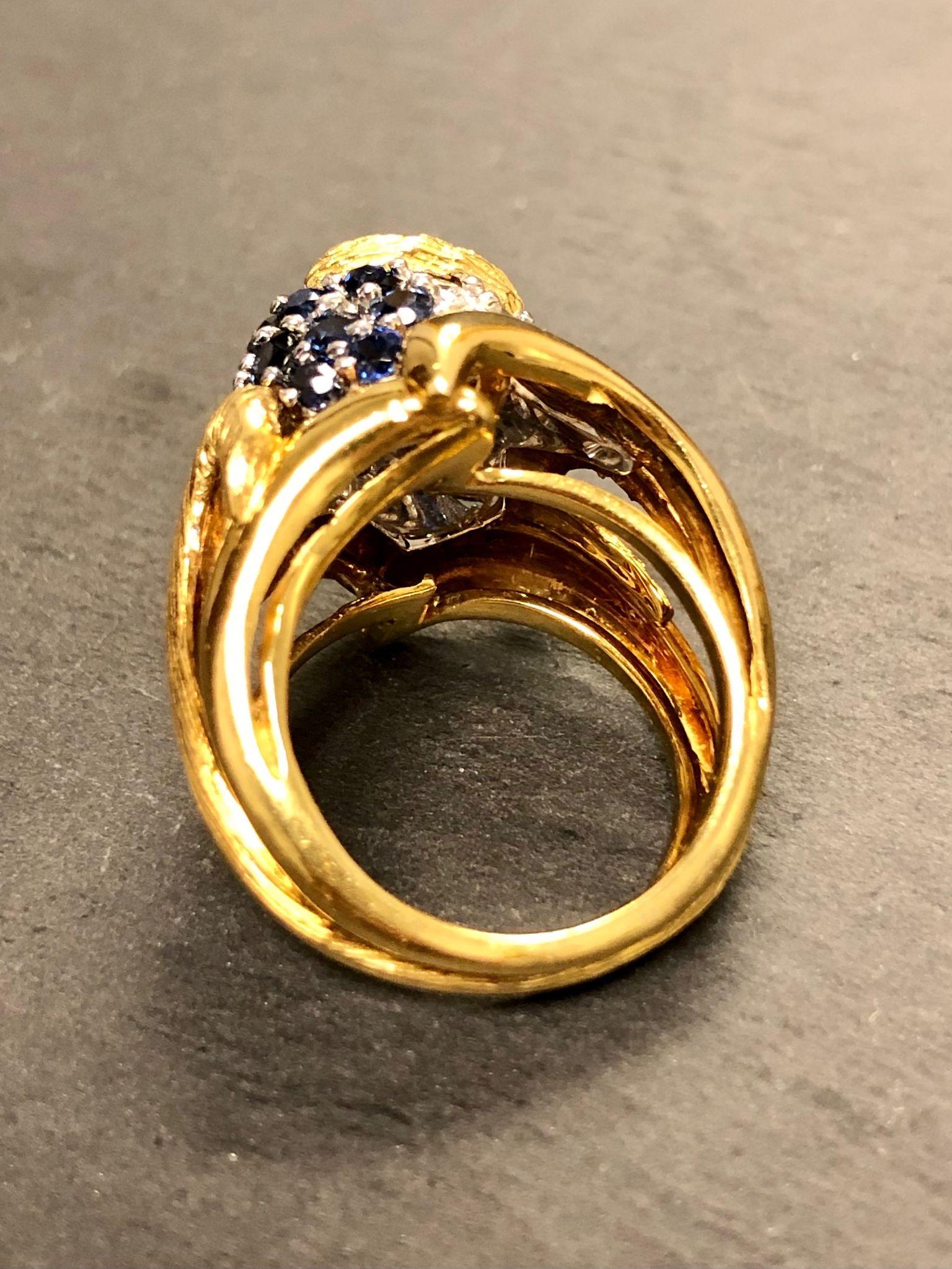 A gorgeously made ring and absolutely full of detail both inside and out. It has been set with approximately 1cttw in G-H Vs2-Si1 clarity round diamonds as well as approximately 1cttw in beautiful natural blue sapphires.

Condition
All stones secure