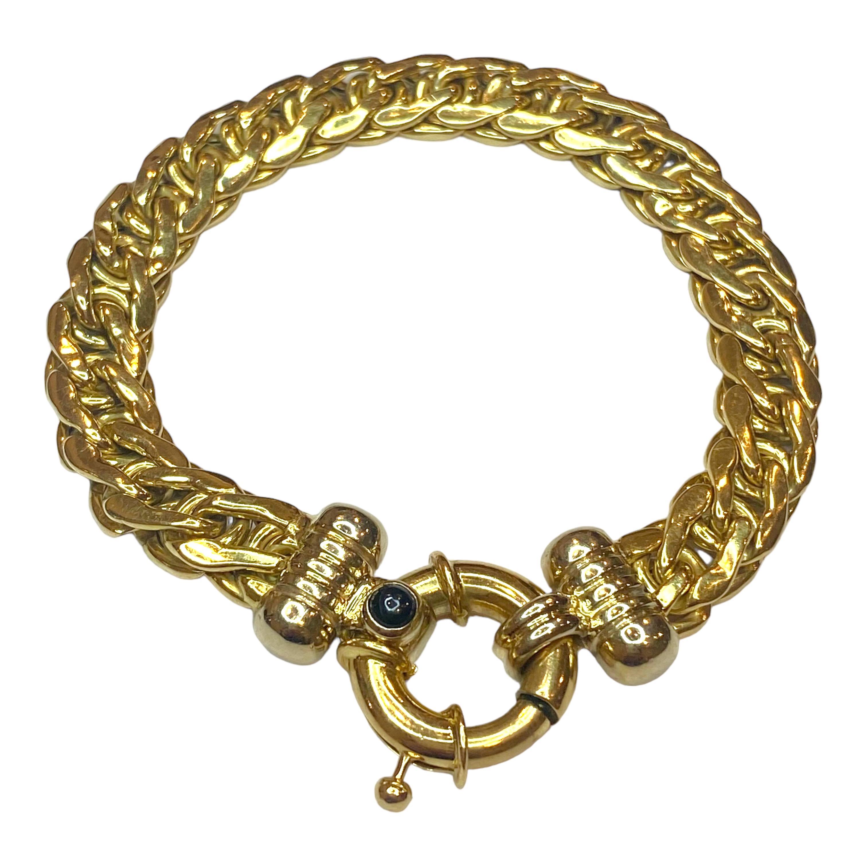 18K yellow gold curb link style bracelet with large spring ring clasp. Accented with a round sapphire cabochon and white gold caps.
Measurements:
Length: 7.5 inches
Width: 18 mm (clasp) - 9.5 mm (chain)
Weight: 26 grams
Marked: 750 and the Italian