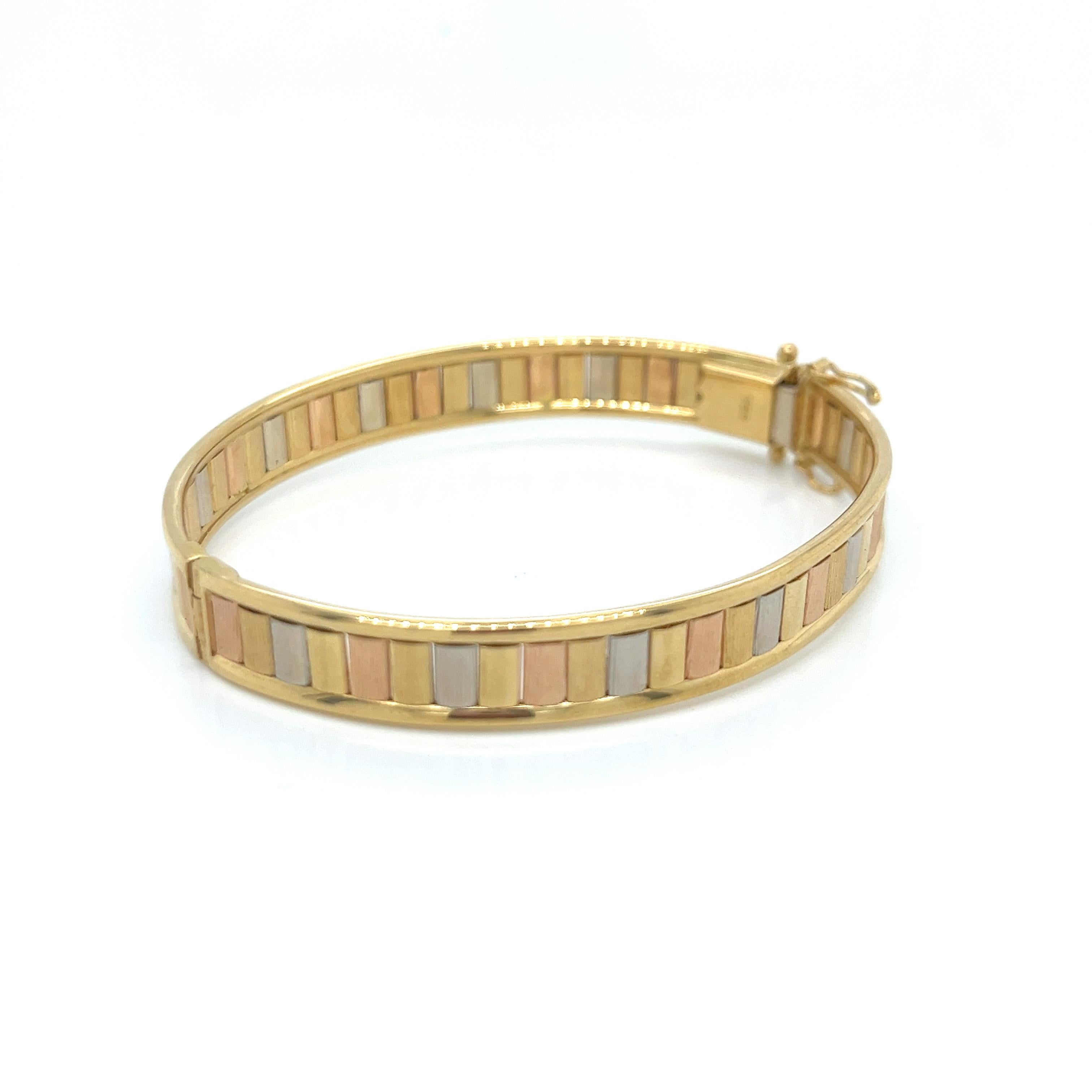 This stunning vintage bangle bracelet is a true masterpiece, showcasing exceptional craftsmanship and artistic flair. Crafted from luxurious 18k gold, verified by the 750 stamp, the design features a harmonious blend of rose, white, and yellow gold