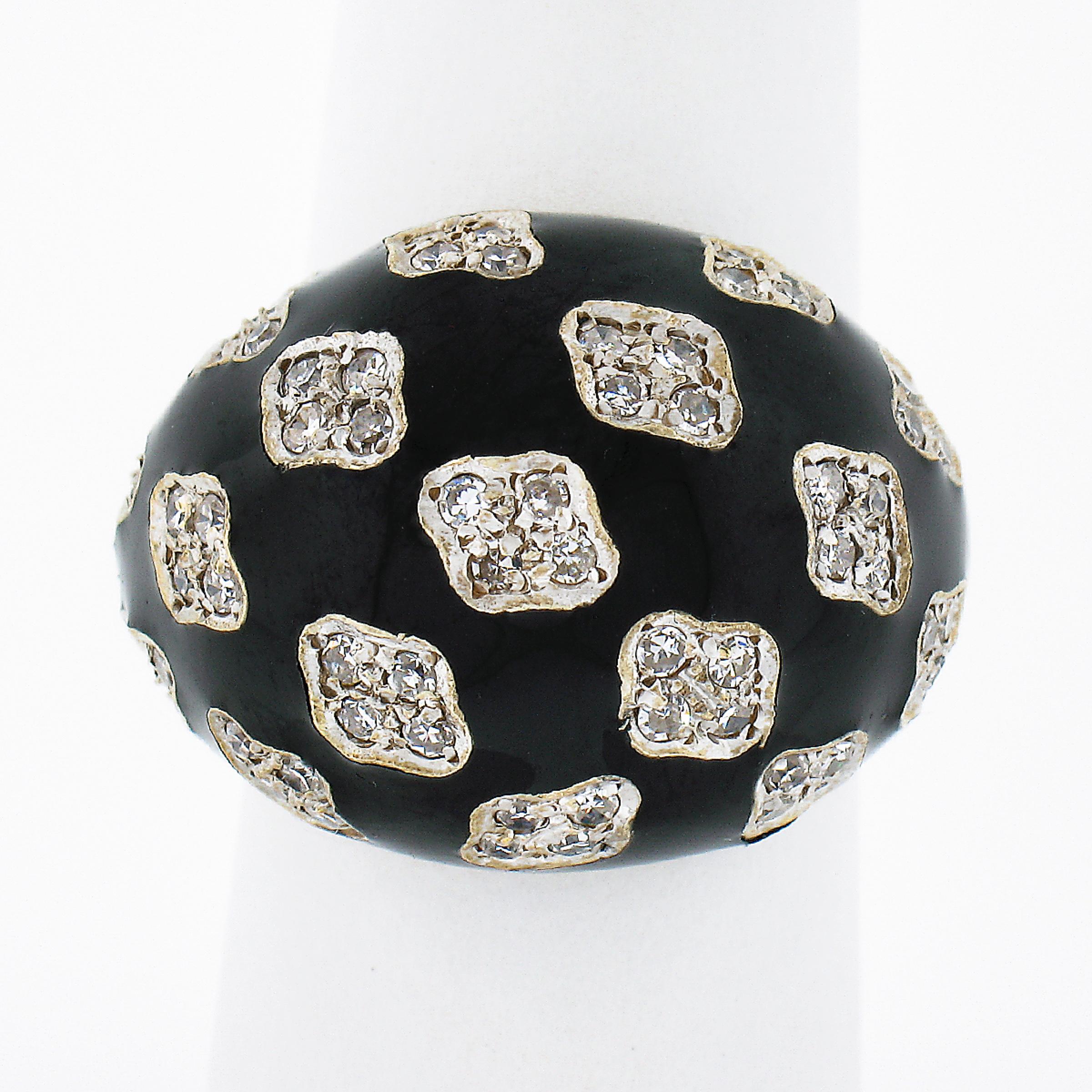 This beautiful vintage bombé ring was crafted from solid 18k yellow and white gold. It features a round domed top of which is adorned with clusters of fine diamonds neatly set throughout and further surrounded by black enamel. The old single cut
