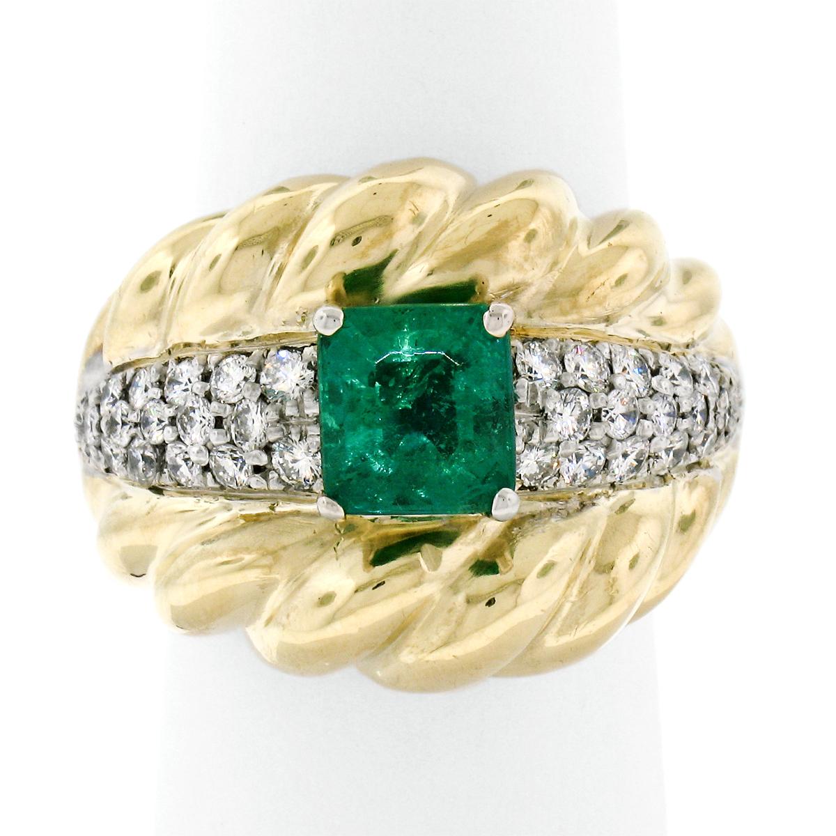 This large, gorgeous cocktail ring was crafted in solid 18k yellow gold and features a magnificent, GIA certified, natural Colombian emerald prong set at its center. This emerald has a very fine, clean and vivid green color that is guaranteed to