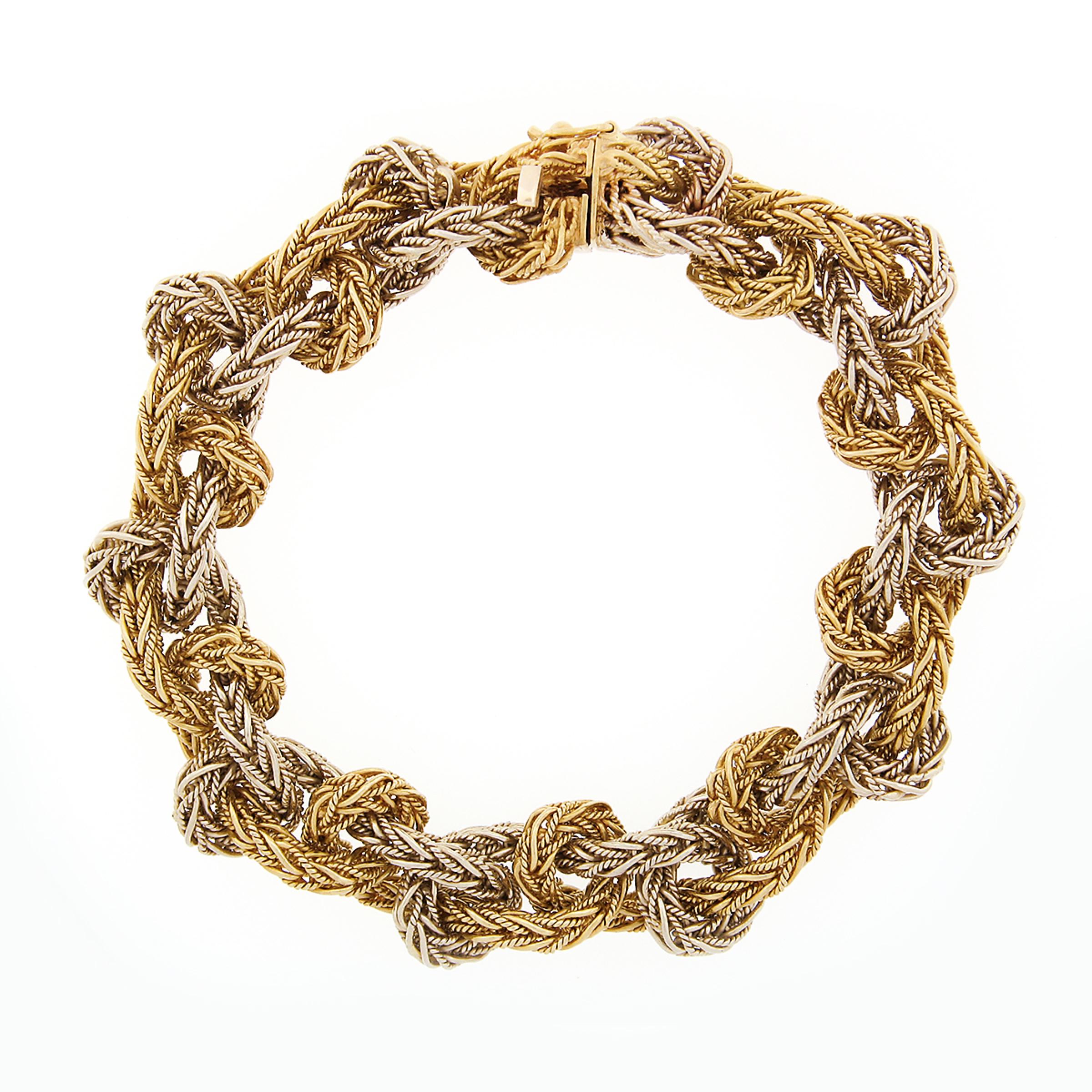 Here we have a beautiful vintage statement bracelet crafted from solid 18k white and yellow gold. The bracelet features wheat link chains in which consist of both polished and twisted wire finish, that are then neatly woven together into a beautiful