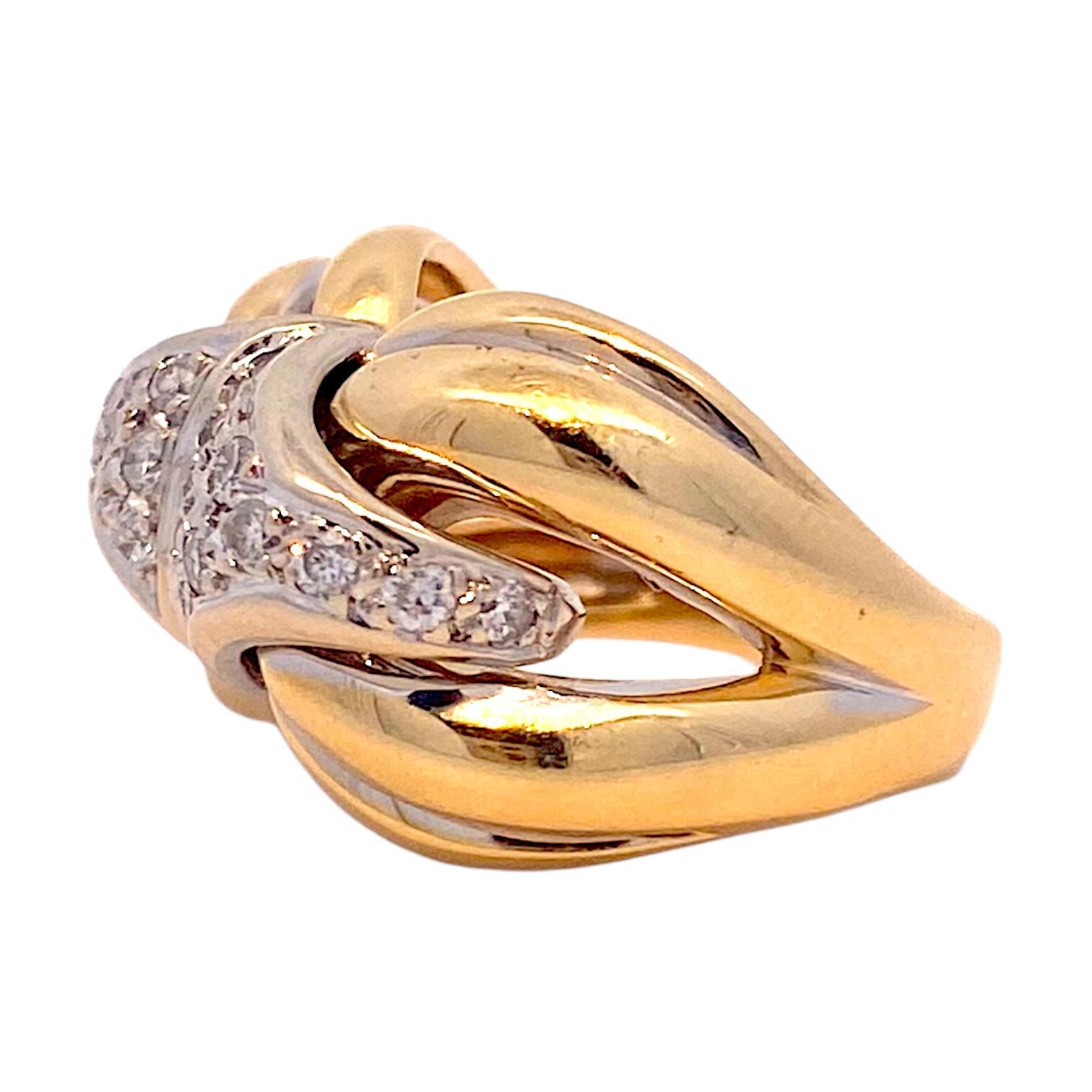 Cocktail ring featuring a bold design. Crafted in 18k yellow gold, the ring showcases a central array of brilliant-cut white diamonds. The gold band is sculpted into a distinctive, interwoven pattern. 
Diamonds: 0.65 ctw. Clarity: SI2-I1. Color: