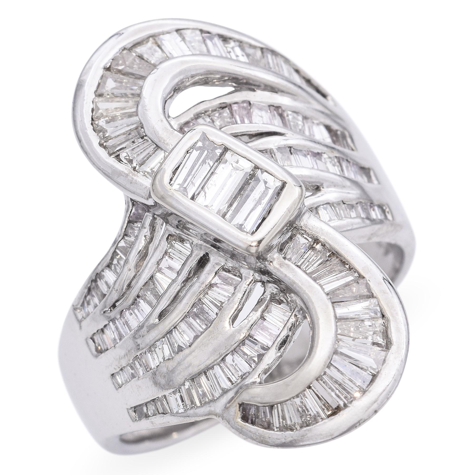 This stunning vintage ring is crafted in 18k white gold and showcases a total of 1.79 carats of sparkling diamonds in a bold Art Deco design. Featuring baguette-cut diamonds arranged in clean geometric lines, the piece captures the elegance and