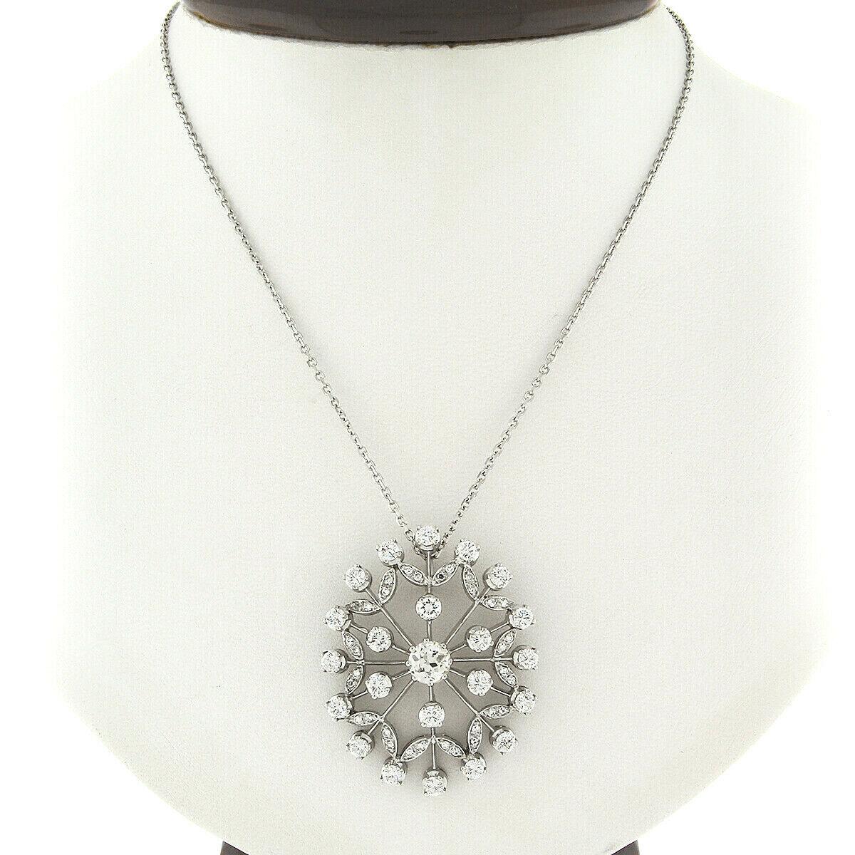 This gorgeous, vintage, floral snowflake pendant was crafted from solid 18k white gold. It features an old European cut diamond multi-prong set at its center weighing approximately 0.80 carats. It is very fine quality with faint yellow K color and