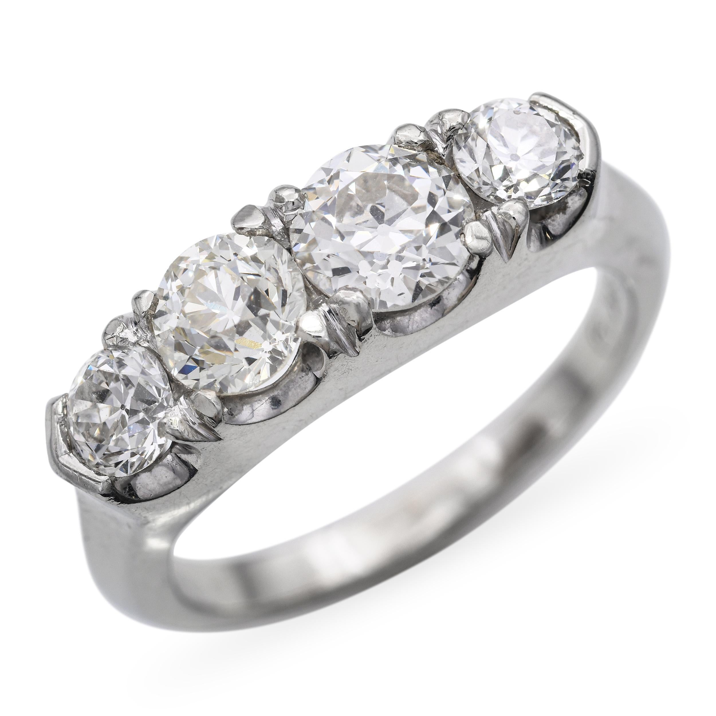 This classic vintage ring is crafted in 18k white gold and features four sparkling diamonds totaling 1.95 carats. The elegant setting allows each stone to shine brilliantly while maintaining a balanced, timeless design. The cool white gold enhances