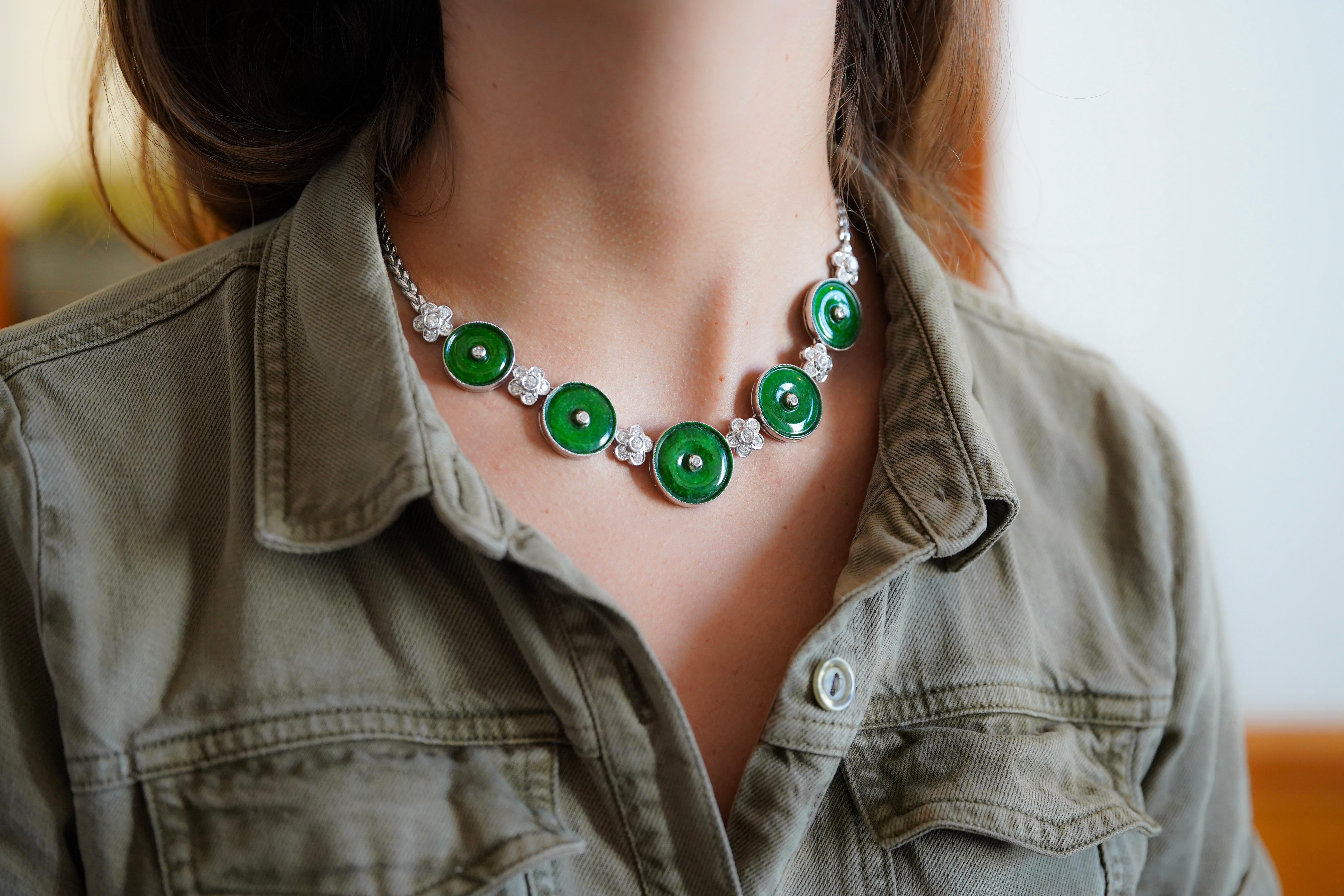 Natural Green Jadeite Jade and Diamond Necklace, gracefully made in 18K White Gold. 

This necklace holds five individual circular-cut Green Jade disks, with brilliant round-cut diamond floral pieces. Secured with a bezel setting and lobster