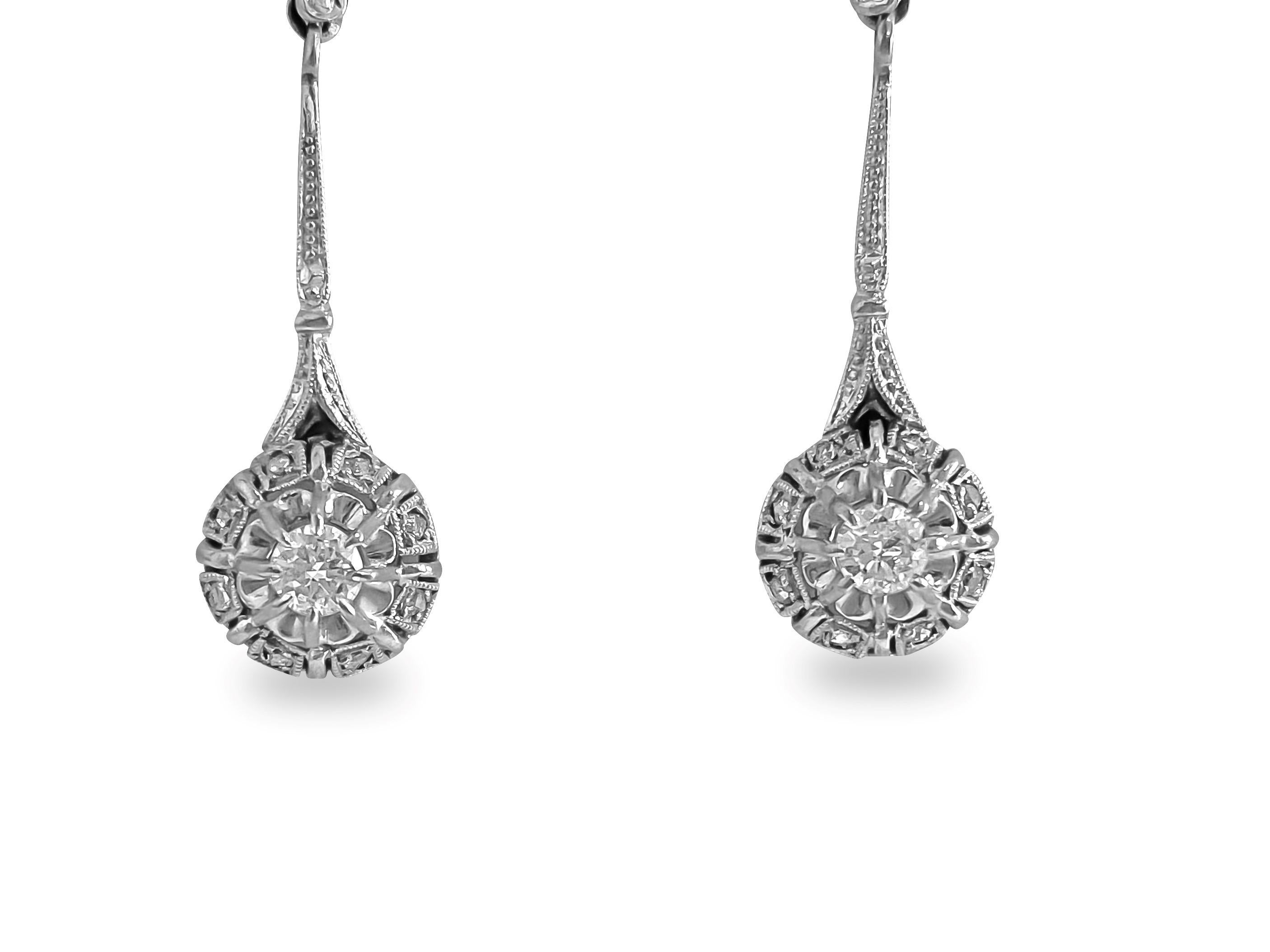 Elevate your elegance with these exquisite vintage diamond dangle earrings, crafted from luxurious 18k white gold. Adorned with a total weight of 0.50 carats of round brilliant cut center diamonds and rose cut side diamonds, each stone boasts VS