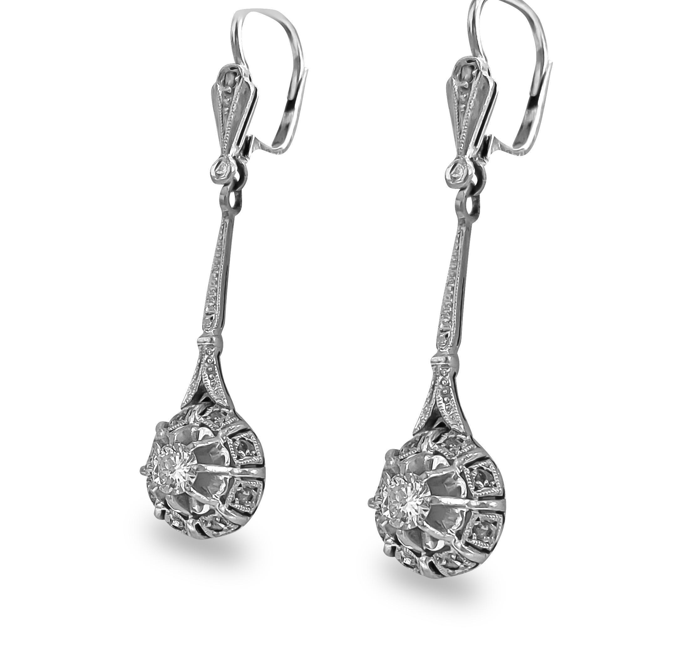 Elevate your elegance with these exquisite vintage diamond dangle earrings, crafted from luxurious 18k white gold. Adorned with a total weight of 0.50 carats of round brilliant cut center diamonds and rose cut side diamonds, each stone boasts VS