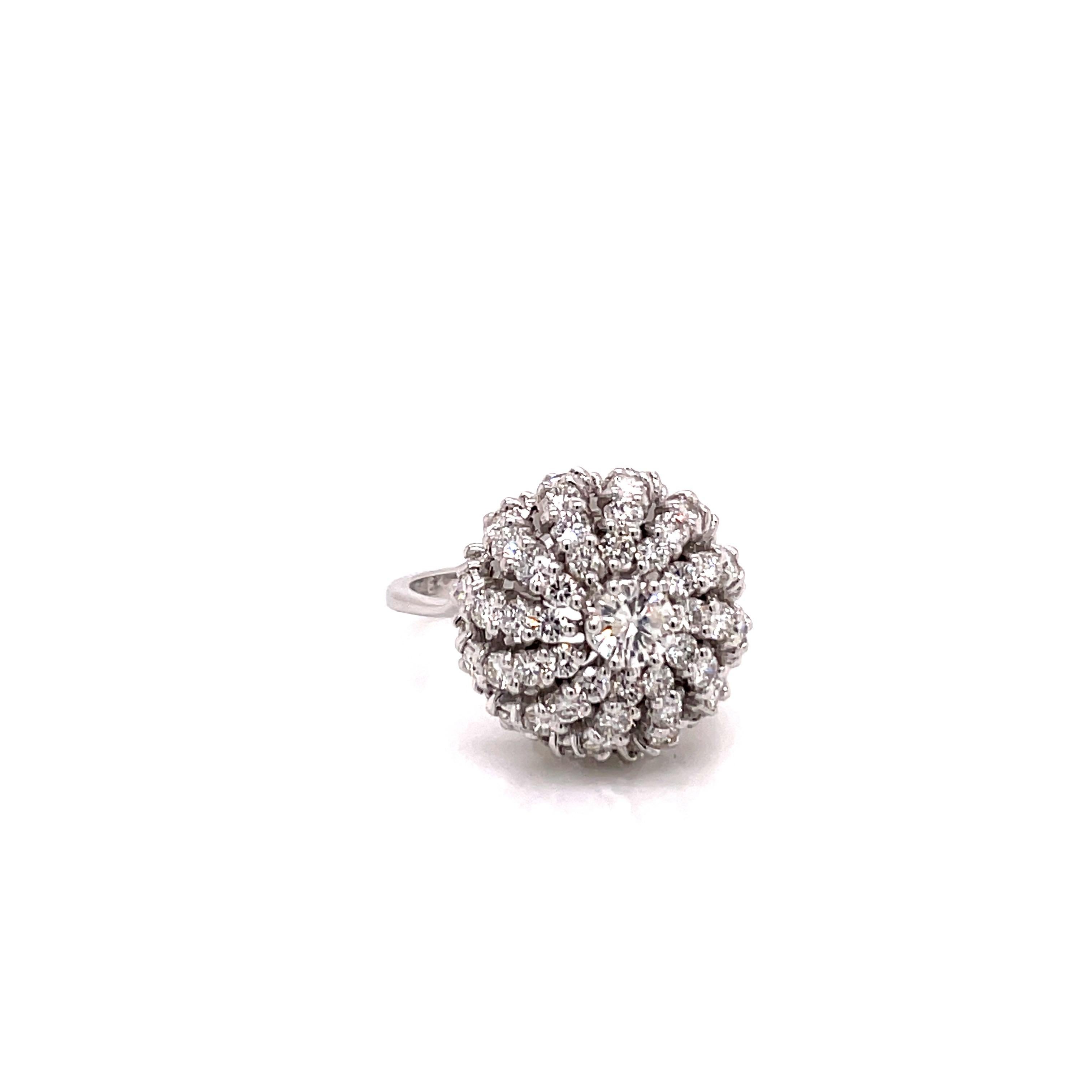 Vintage 18K White Gold Diamond Flower Cocktail Ring - The ring contains 1 round brilliant diamond on the top weighing approximately .36ct with H color and I1 clarity (no black inclusion). Surrounding the center are 60 round brilliant diamonds which