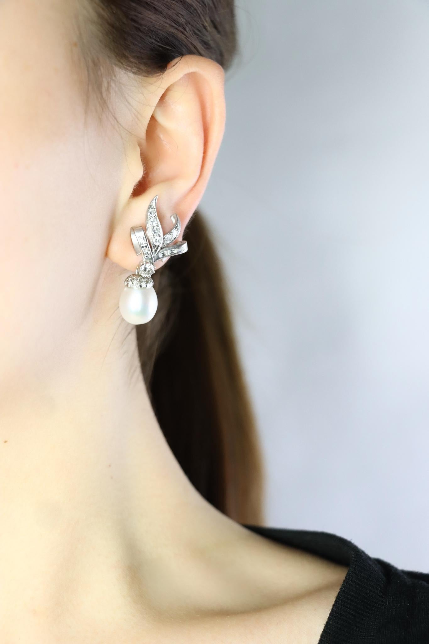 Vintage 18K White Gold Diamond Pearl Drop Earrings
18K White Gold earrings mounted with Approximately 2.8 (+/-) carats of mixed cut Diamonds and (2) sizable Oval Pearls

Approximate Dimensions:
4 cm (Length) 
1.7 cm (Width)
13 mm - 15 mm