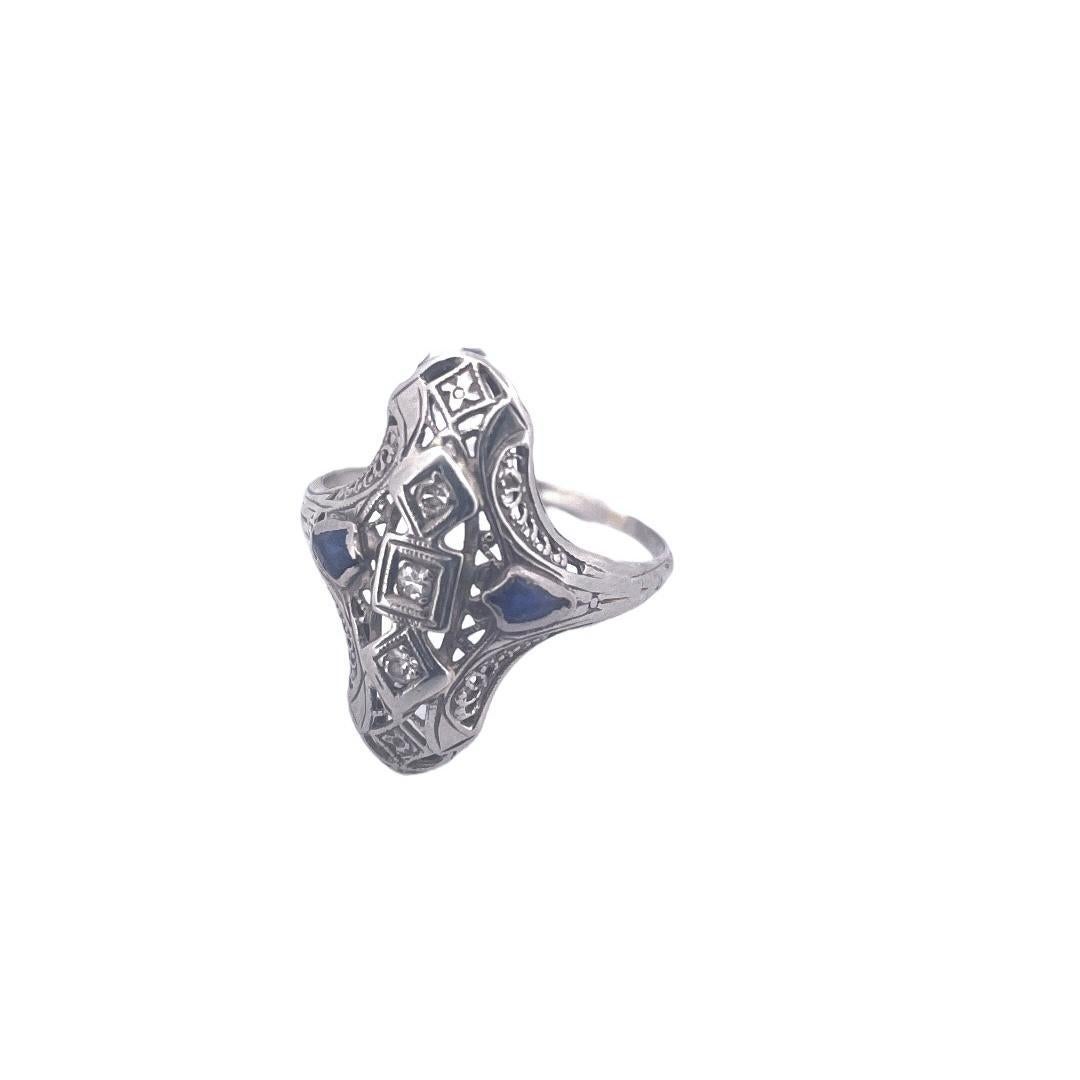 Indulge in sheer elegance with this exquisite 18K white gold filigree ring, adorned with diamonds and sapphires. 
At just 2.2 grams, this delicate masterpiece combines timeless beauty with a touch of luxury.

Material: 18K White Gold
Weight: 2.2