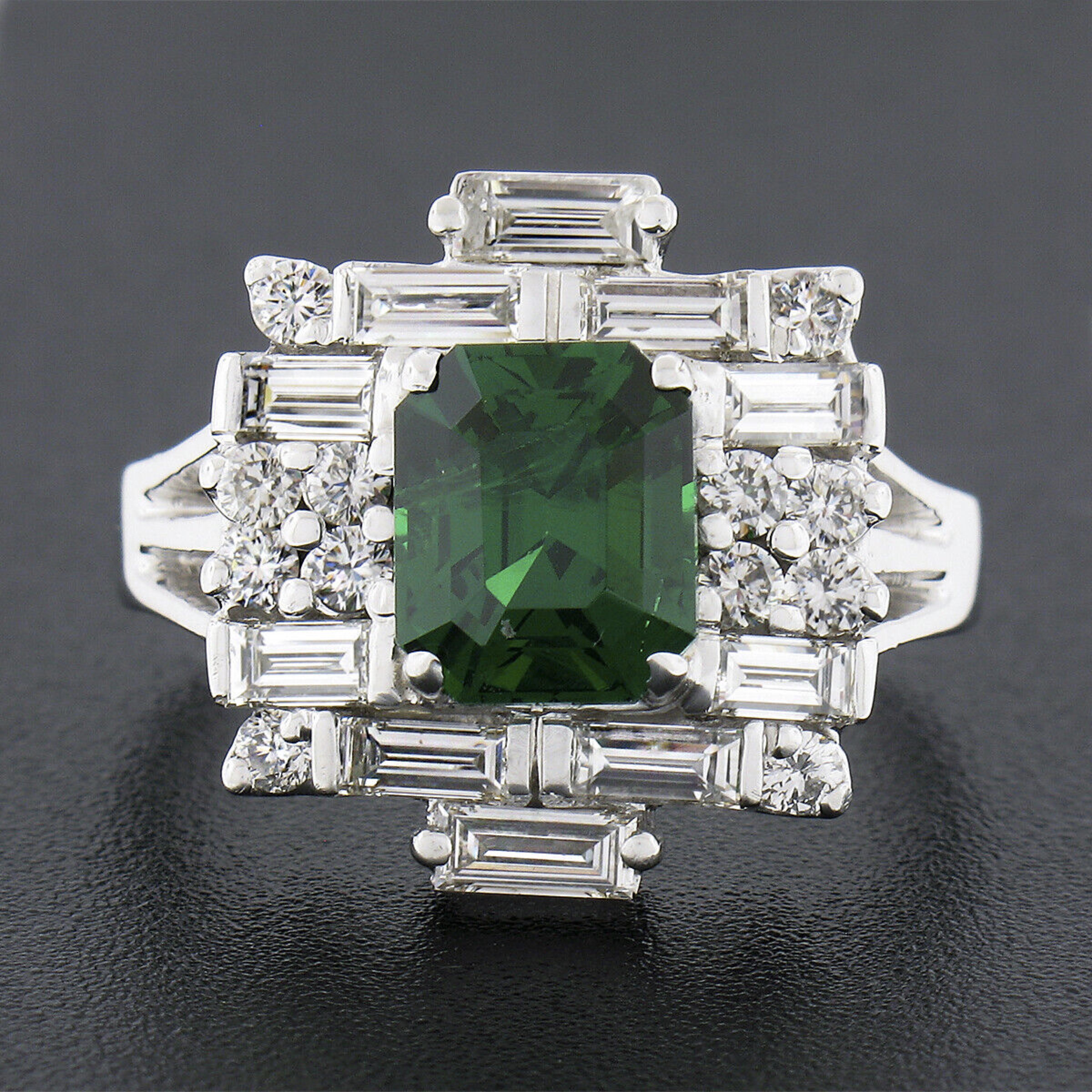 This gorgeous vintage statement ring is very well crafted in solid 18k white gold and features a GIA certified emerald cut tsavorite stone with an incredible deep and vivid green color weighing exactly 3.03 carats. This fine quality tsavorite is