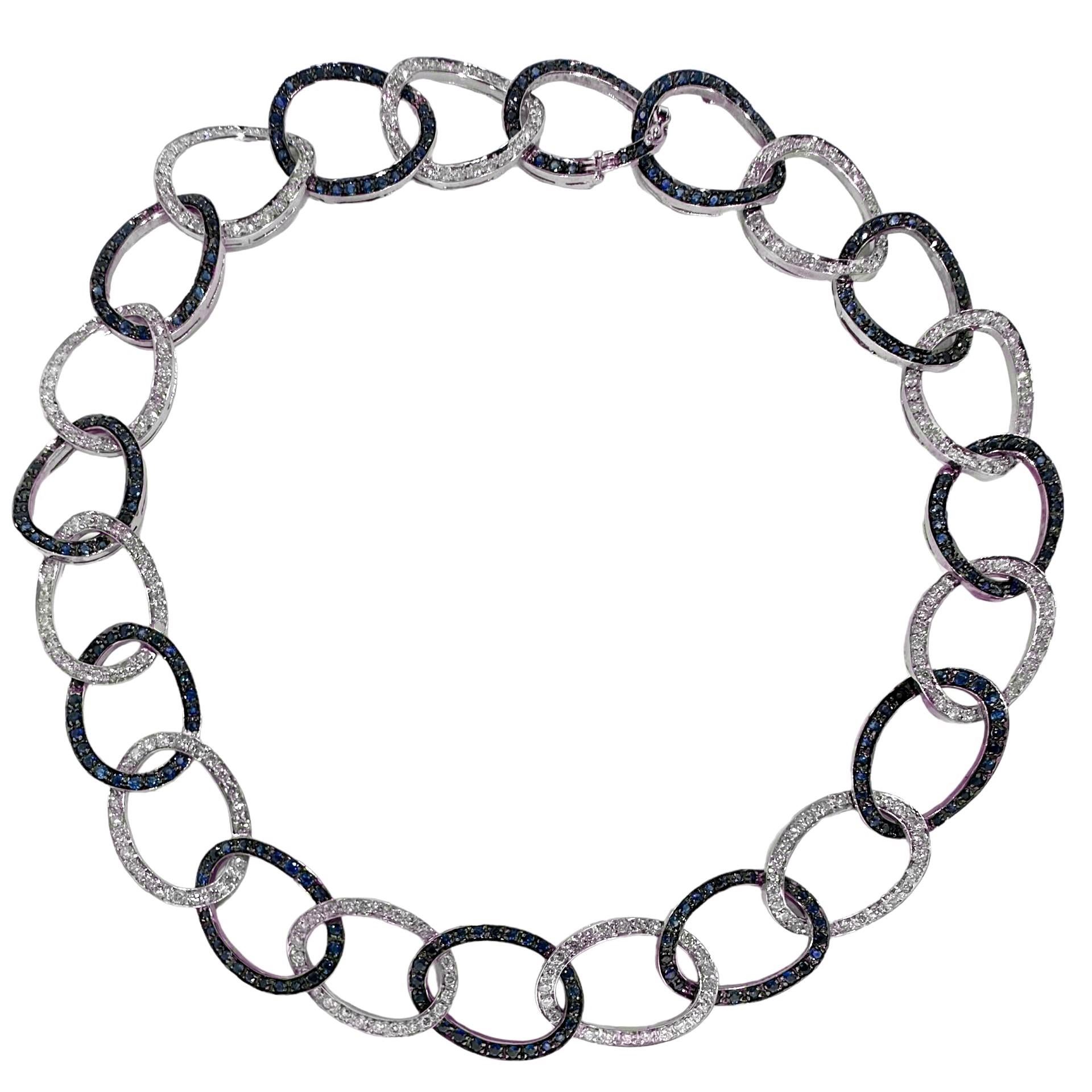 This lovely and tasteful late 20th century choker length 18k white gold necklace is set with hundreds of vivid natural blue sapphires and brilliant cut diamonds in alternating links. The contrast thus created is striking and visceral. All sapphires