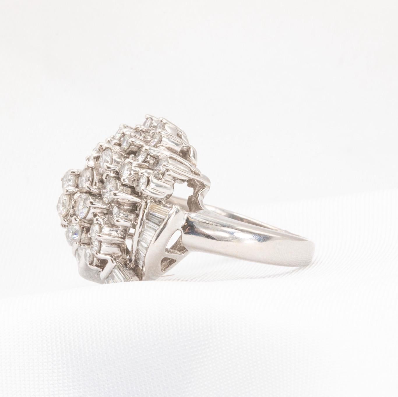 Vintage Baguette and Round Brilliant Diamond Cocktail Ring, 1.5 CTW  

This exquisite vintage cocktail ring features a timeless design with two diamond cuts: baguette and round brilliant. The approximately 1.5 CTW diamonds are of exceptional