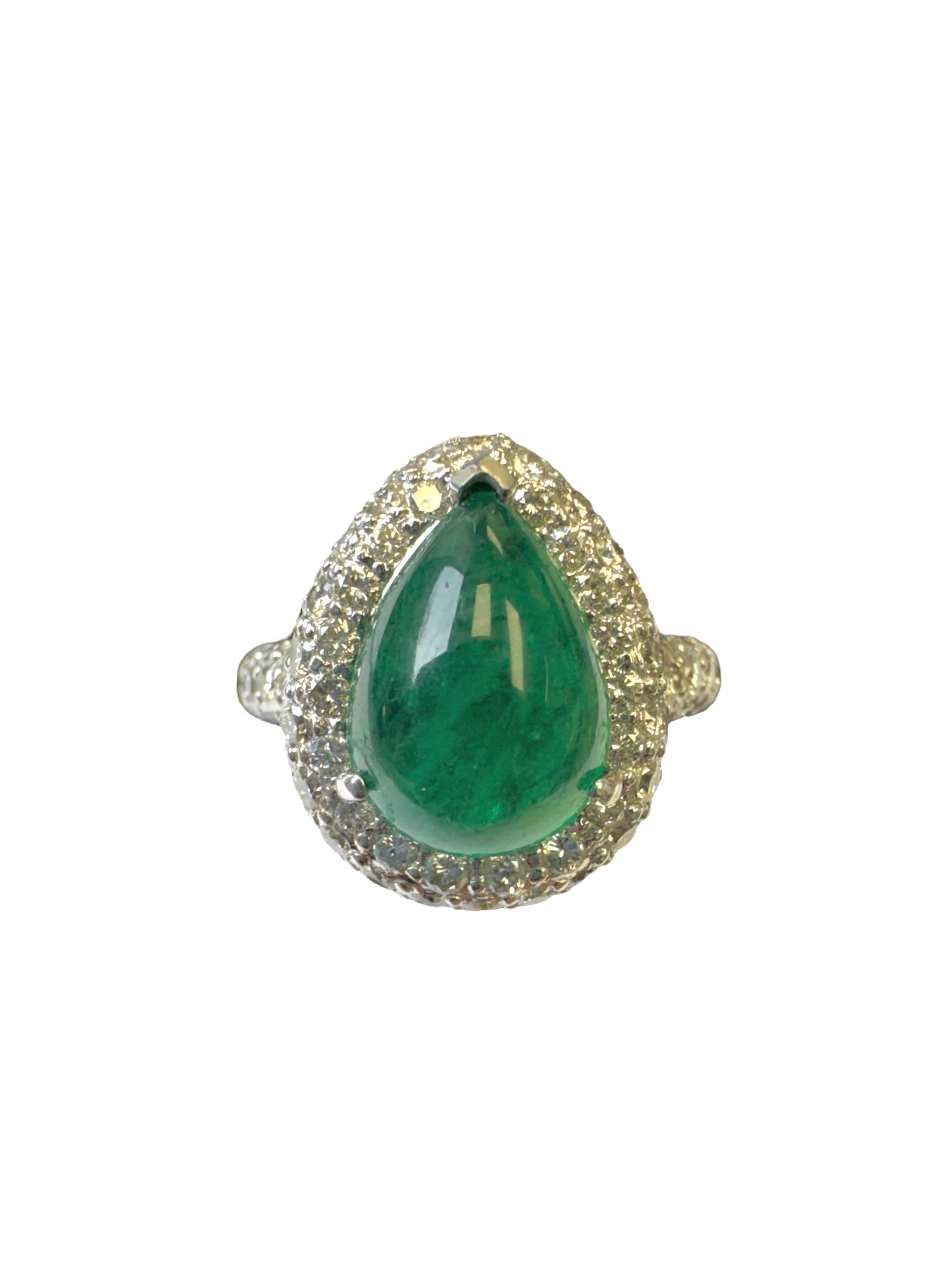 Make a bold yet elegant statement with this striking vintage cocktail ring, finely crafted in 18 karat white gold. At its center sits a luminous pear-shaped cabochon emerald weighing approximately 2.50 carats, celebrated for its vivid green hue and