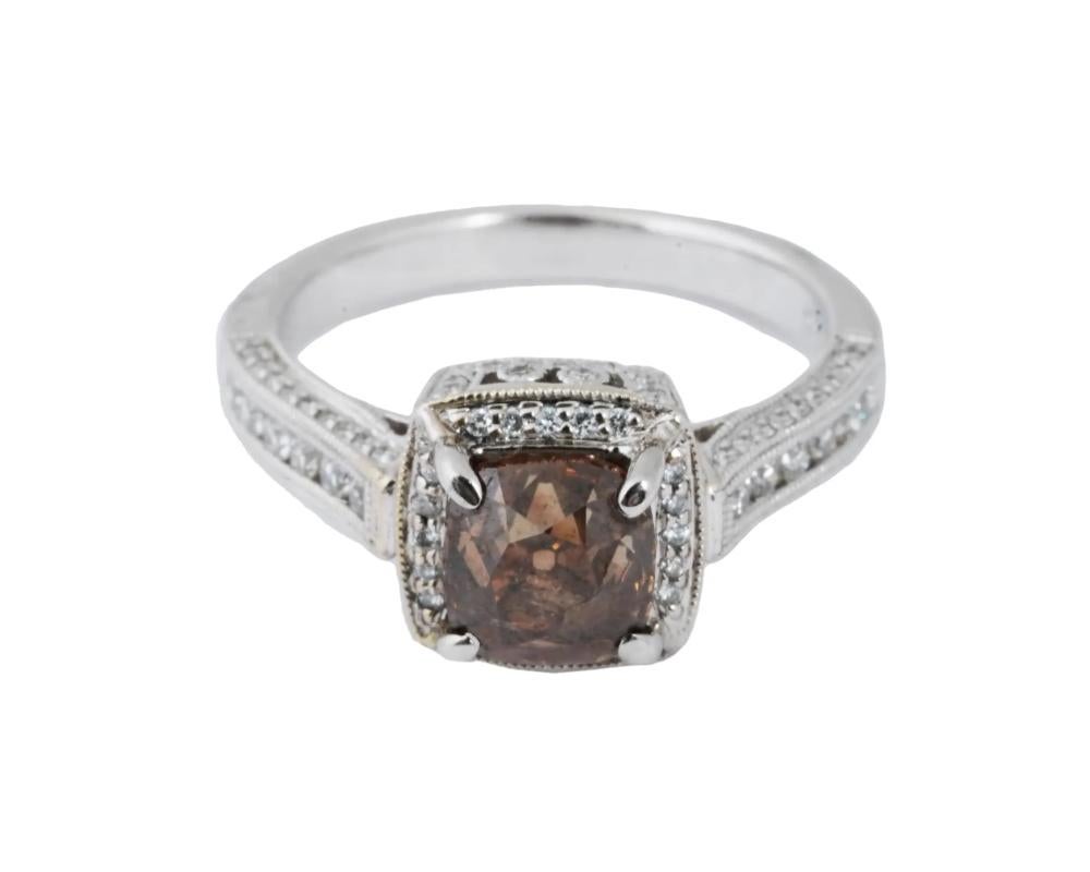 A vintage 18K white gold cocktail ring. The central cushion-cut smoky quartz stone is encompassed and flanked with three rows of diamonds. Marked 18K, D043 on the inside. Total Weight: 5 grams. Elegant Jewelry For Women.

OVERALL GOOD VINTAGE