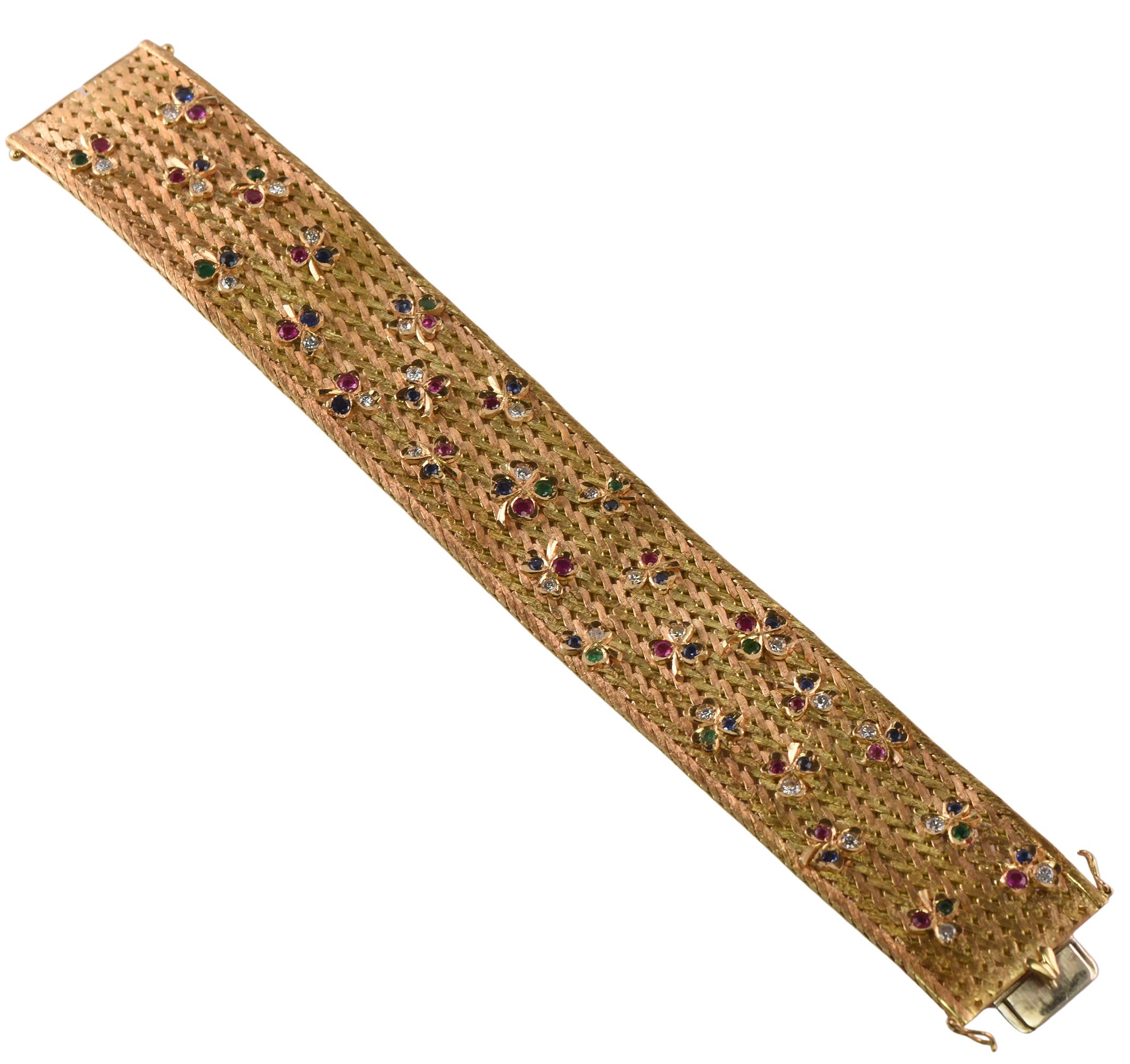 Heavy vintage 18 carat gold woven bracelet adorned with gem set shamrocks with diamond sapphires, ruby's and emeralds.