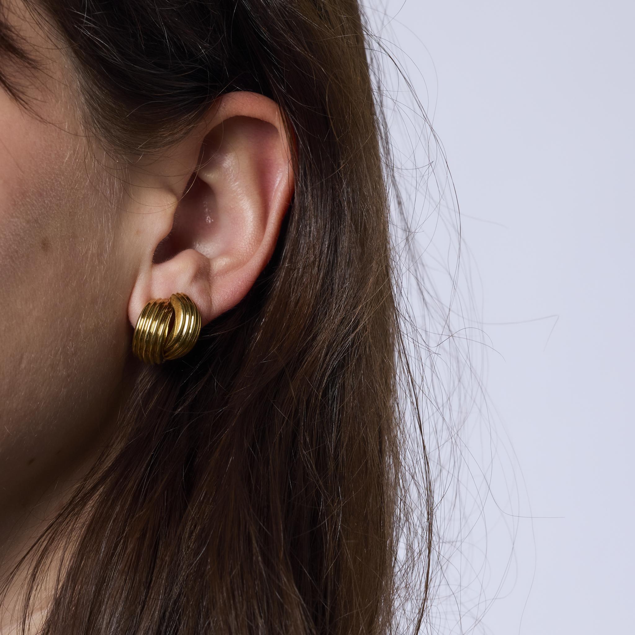 These chic vintage earrings feature a stylish mix of 18k yellow and white gold. With their elegant two-tone design and timeless 1990s craftsmanship, they offer a versatile and sophisticated accent to any look.