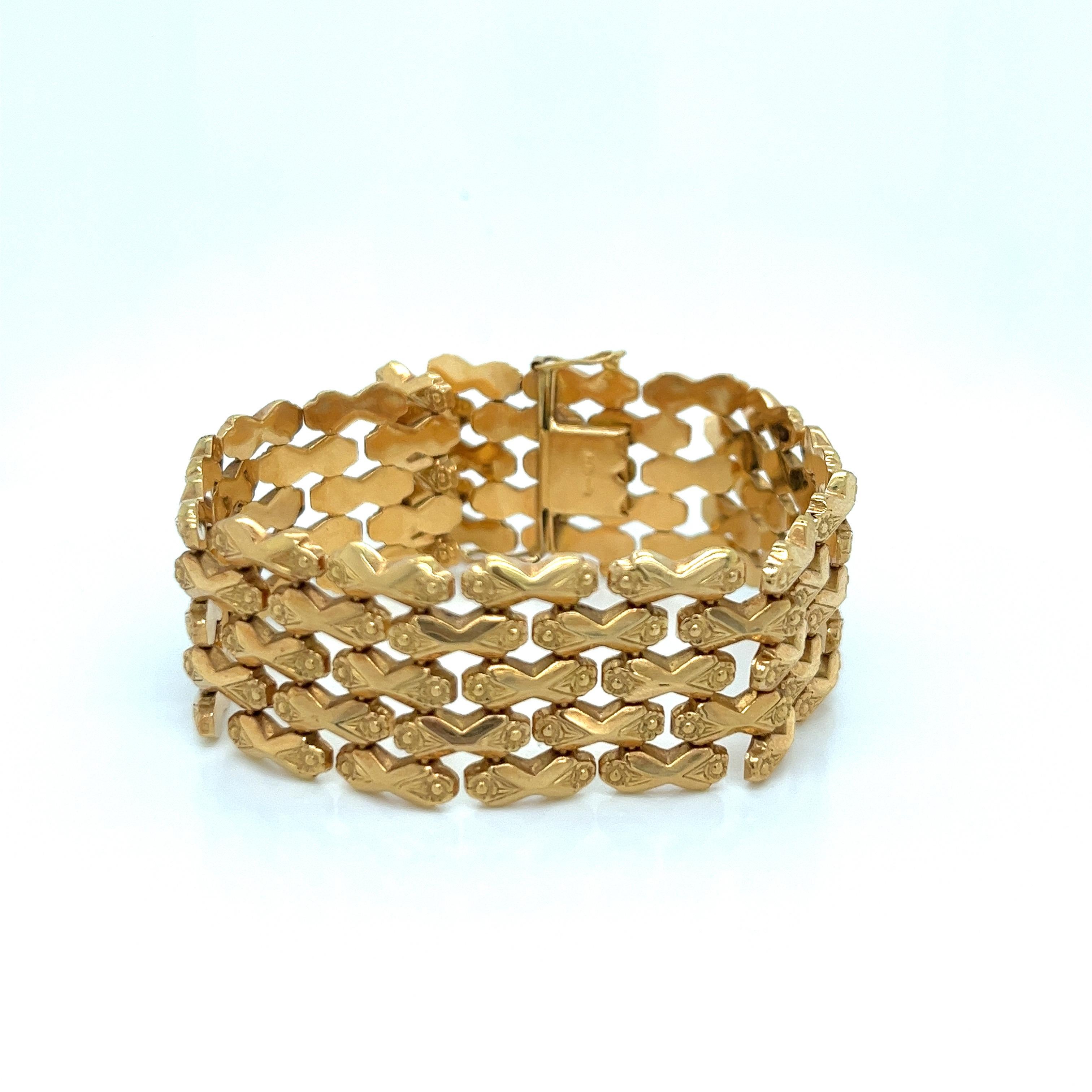 This exquisite vintage bracelet from the 1940s-1950s era showcases the artistry and craftsmanship of its time. Crafted in luxurious 18k yellow gold, verified by the 750 stamp, the design features a striking 5-row wide link pattern adorned with