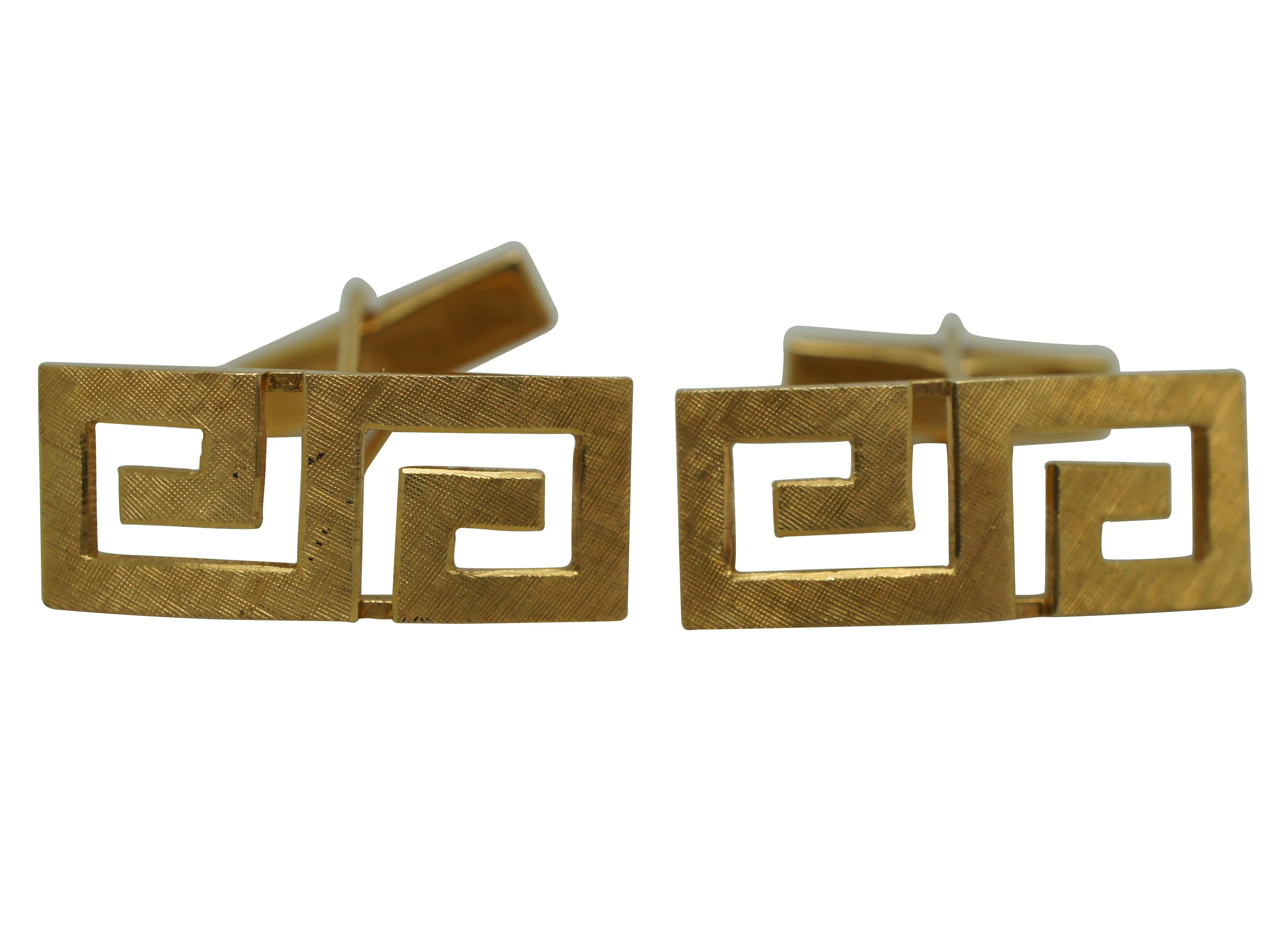 Pair of vintage 18K yellow gold men’s cufflinks in the shape of a Greek Key pattern with cross hatched surface texture.