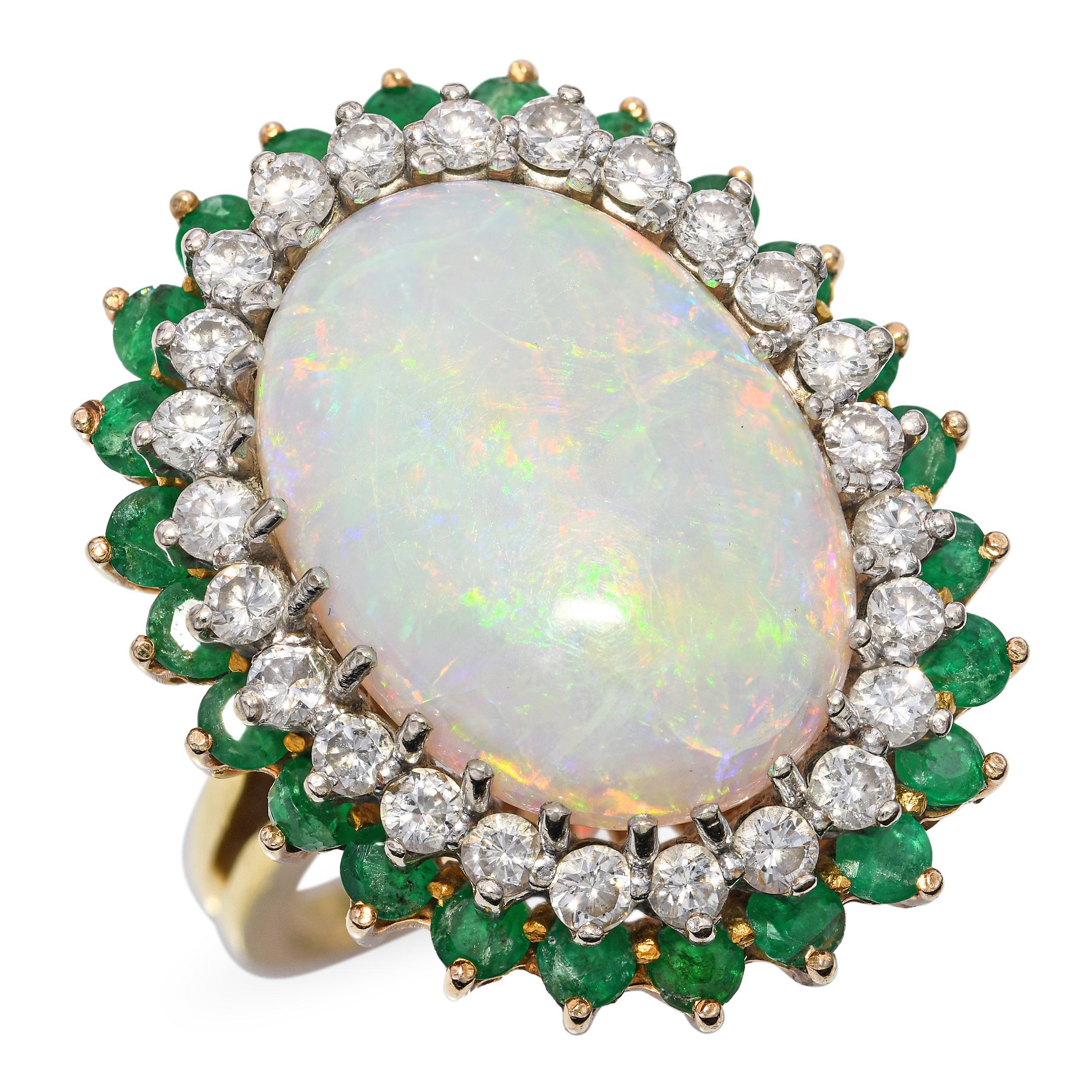 This breathtaking vintage ring is crafted in 18k yellow gold and showcases a mesmerizing 9.35ct Australian opal with vibrant flashes of color. Surrounding the opal are sparkling diamonds and vivid emeralds, creating a striking contrast that enhances