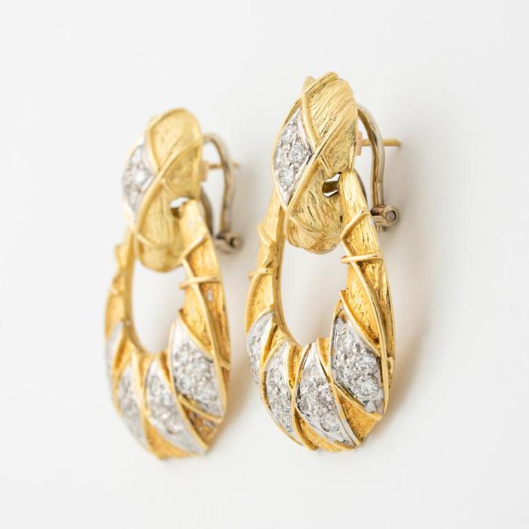 Vintage 18K Yellow Gold and 2.)CT Diamond Door Knocker Earrings
Period: Vintage
Year: c.1980
Material: 18K Yellow Gold, 2.0ct Diamond
Weight: Each earring weighs 11.5 grams
Length of each earing from post is 1.5 inches/3.81 cm Width: 1 inch/2.54